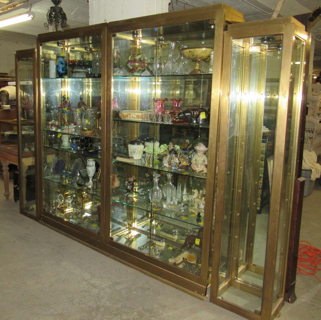 Large Brass Finish Wall Display Curio Shelf Unit: Approx 14" x 10'5"x 86" tall. This is a 4 section lighted unit, with mirror backing. We did get the shelves for the 2 end sections. This has brass finish. DOES NOT INCLUDE ITEMS IN IT