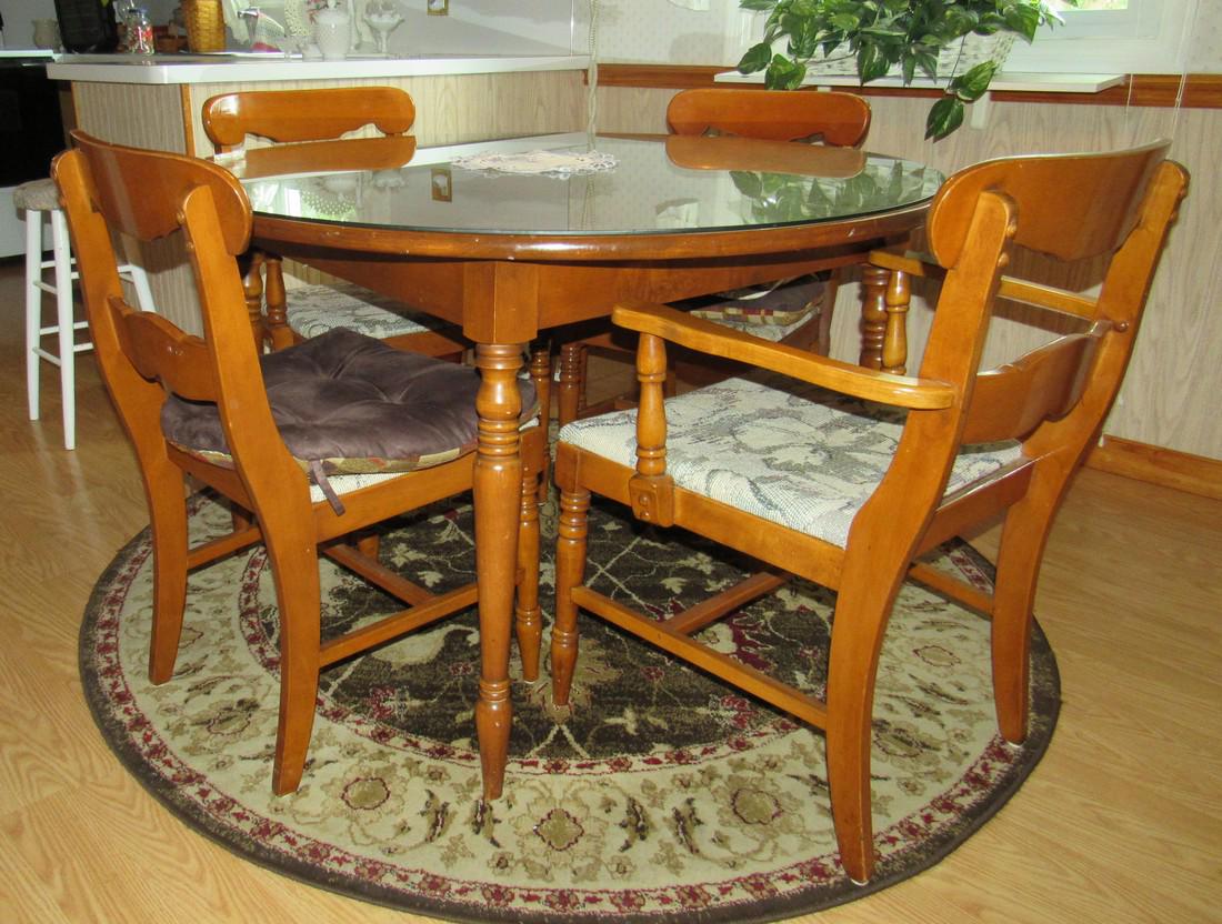 Maple Craddock Table and 4 Chairs: 2 are armchairs. Table is approx 47 1/4" in diameter with a glass top. Comes with 2 extra leaves