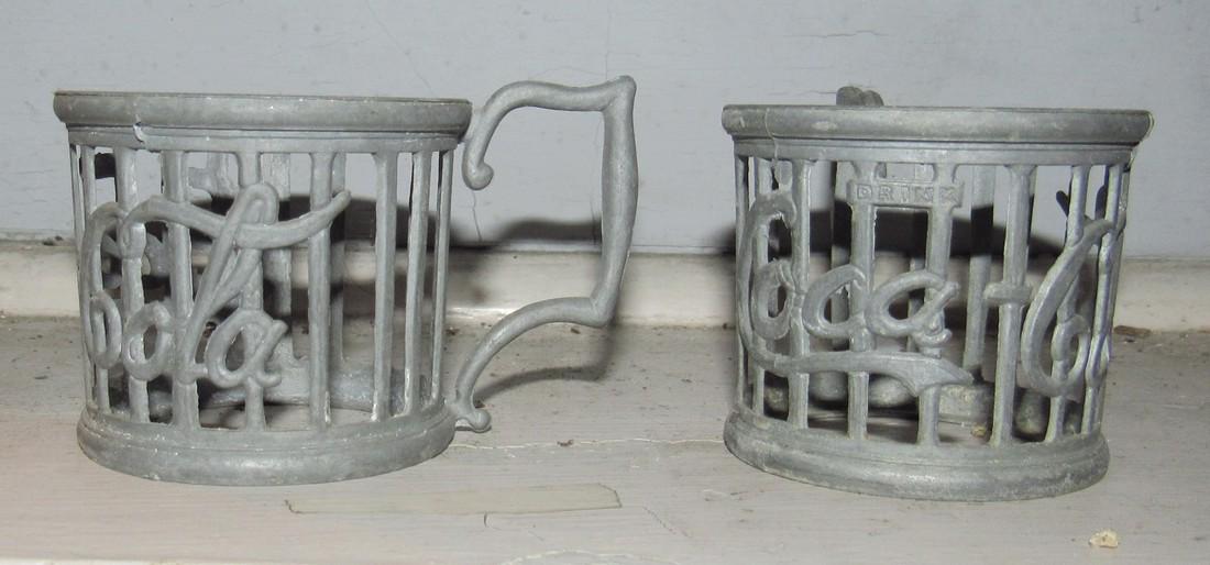 2 Vintage Coca Cola Cup holders: Approx 2 1/2" in diameter ad 2 1/8" tall. Made of cast aluminum
