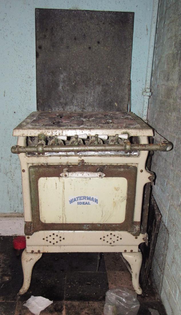 Waterman Ideal Gas Stove: Approx 24" x 24" x 34". Buyer's responsibility to unhook