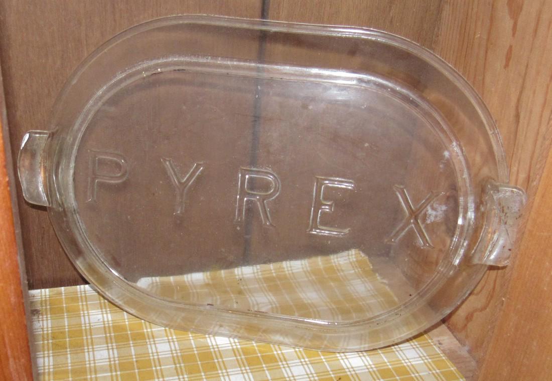 Cabinet Filled with Misc Pyrex Glasbake: Large casserole lid in bottom is approx 10 1/4" x 15" long. Cabinet and items on top are included. Cabinet is approx 13" x 34" x 65"