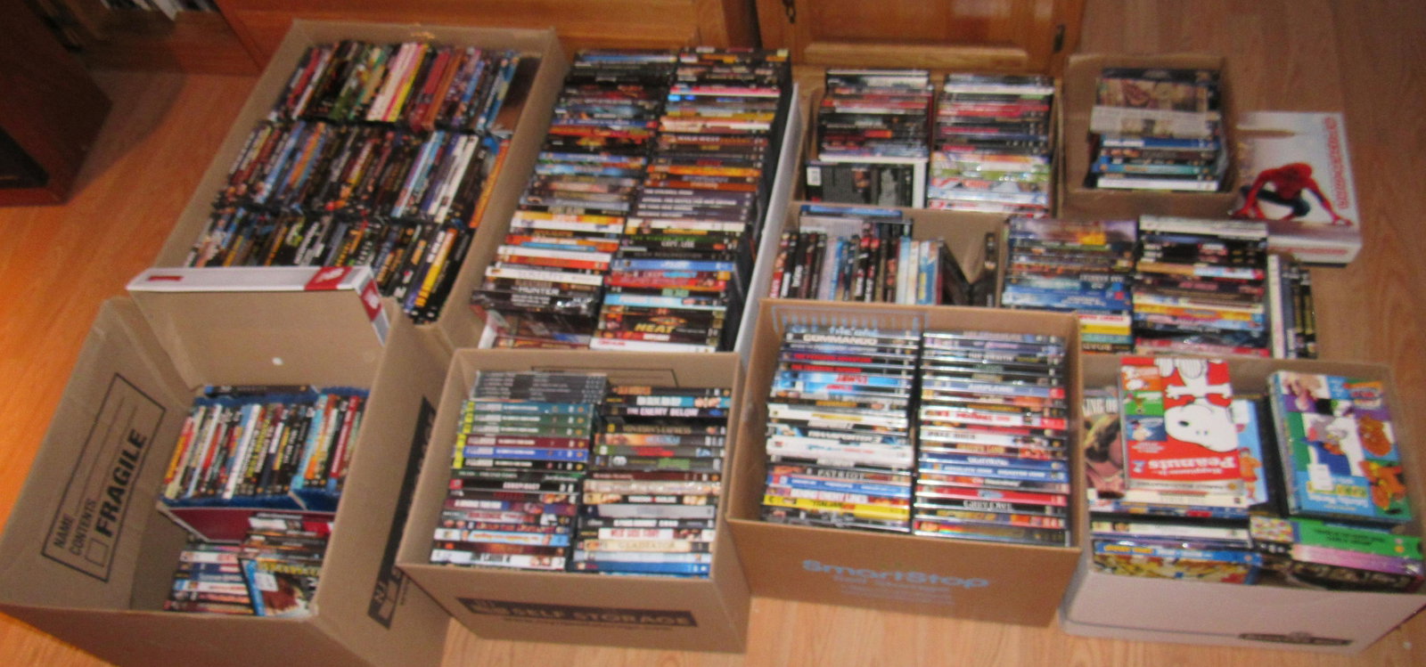 HUGE Lot of DVD's VHS Tapes & Revolving Shelf: Lot includes all Movies in boxes and the shelf. The shelf is approx 18 3/4" x 18 3/4" x 50 1/2" tall. Movies are staked in the boxes. There are a lot more than what you see !