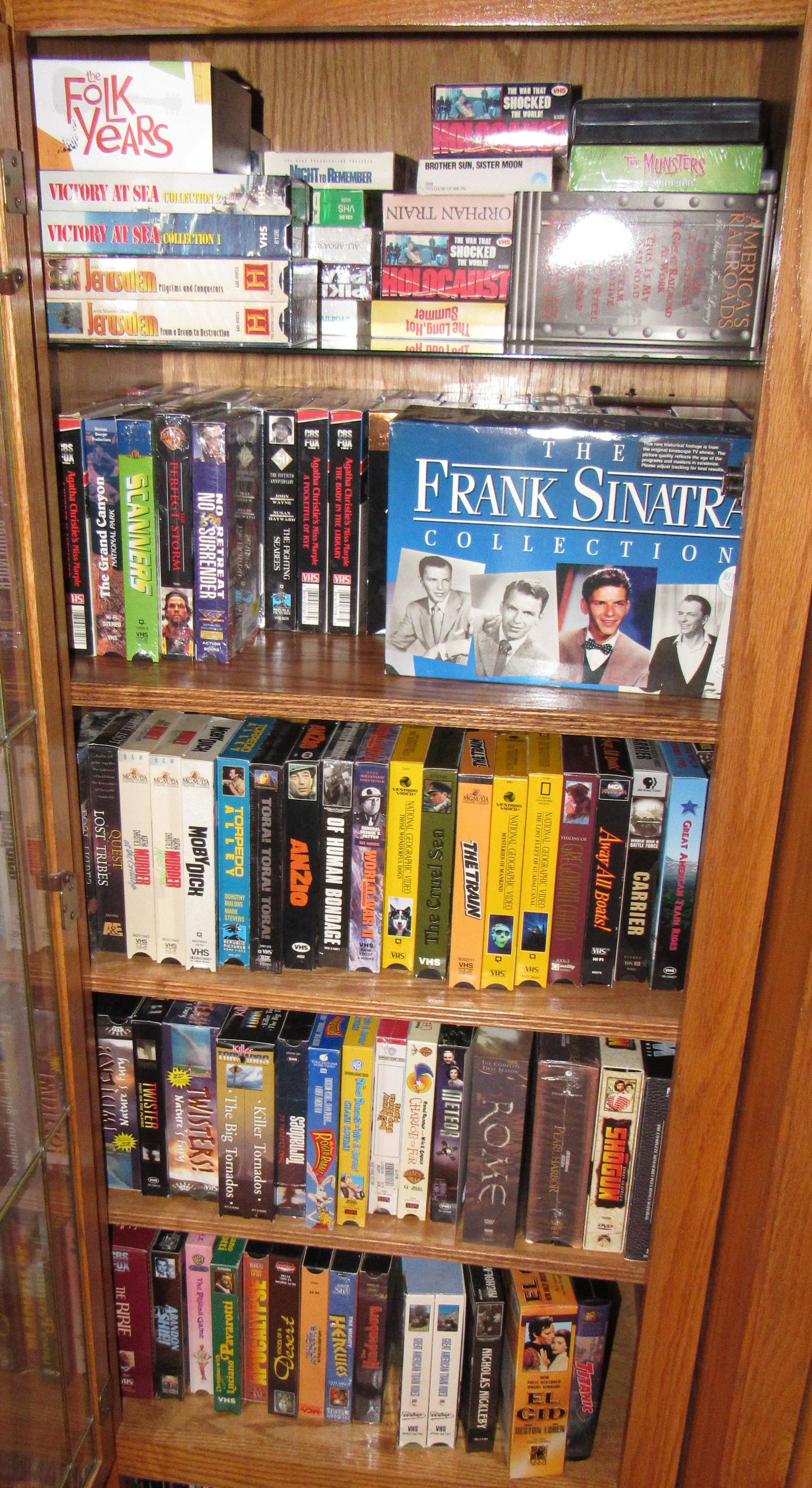 Large Lot of VHS Tapes: Lot includes all pictured in cabinet and on tower. Tower is apprx 45" tall.