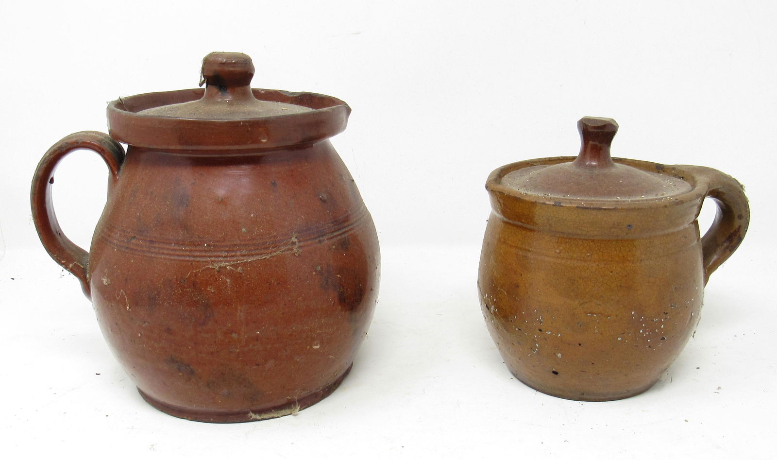2 Redware Pitchers: Largest is approx 7 3/4" tall.
