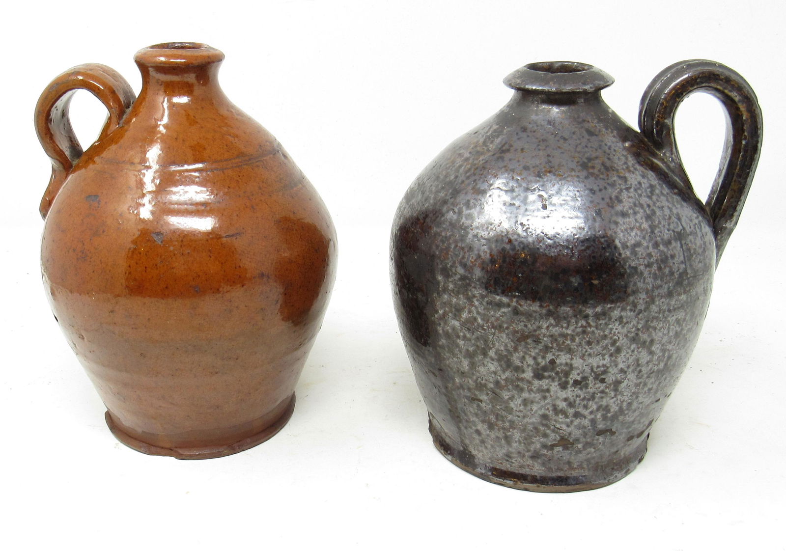 2 Redware Pottery Jugs: Approx 7 1/2" tall.
