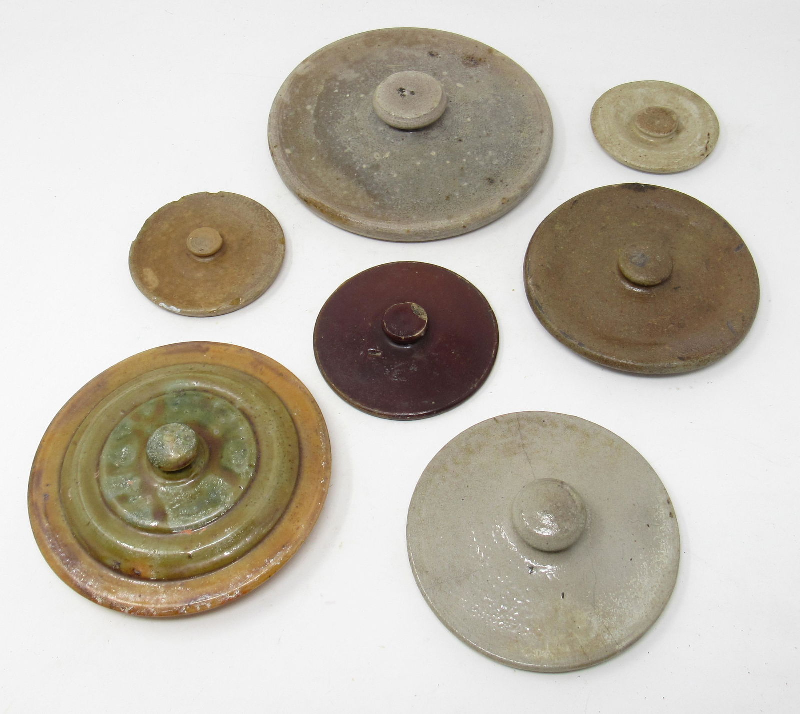 Stoneware and Redware Pottery Lids: Largest is approx 6 7/8" in diameter
