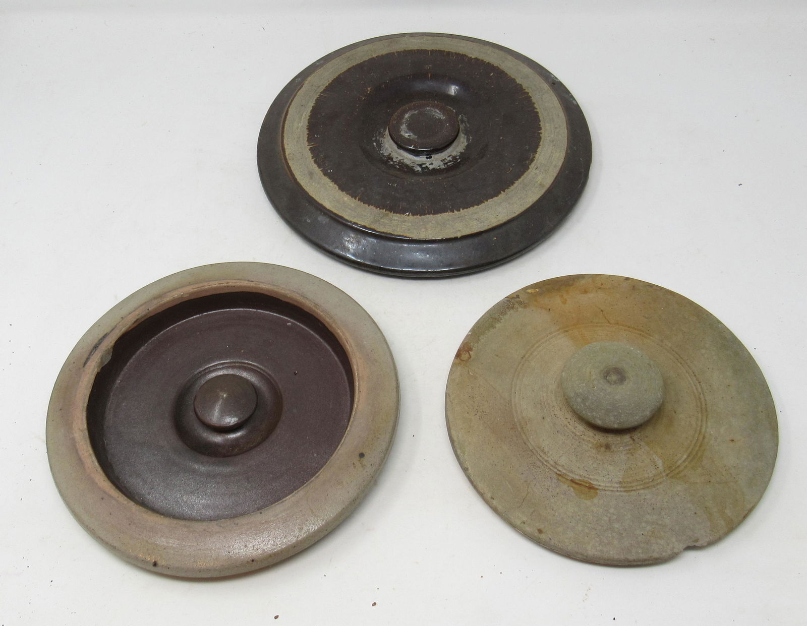 3 Stoneware Crock Lids: Largest in back is approx 9 1/2" in diameter