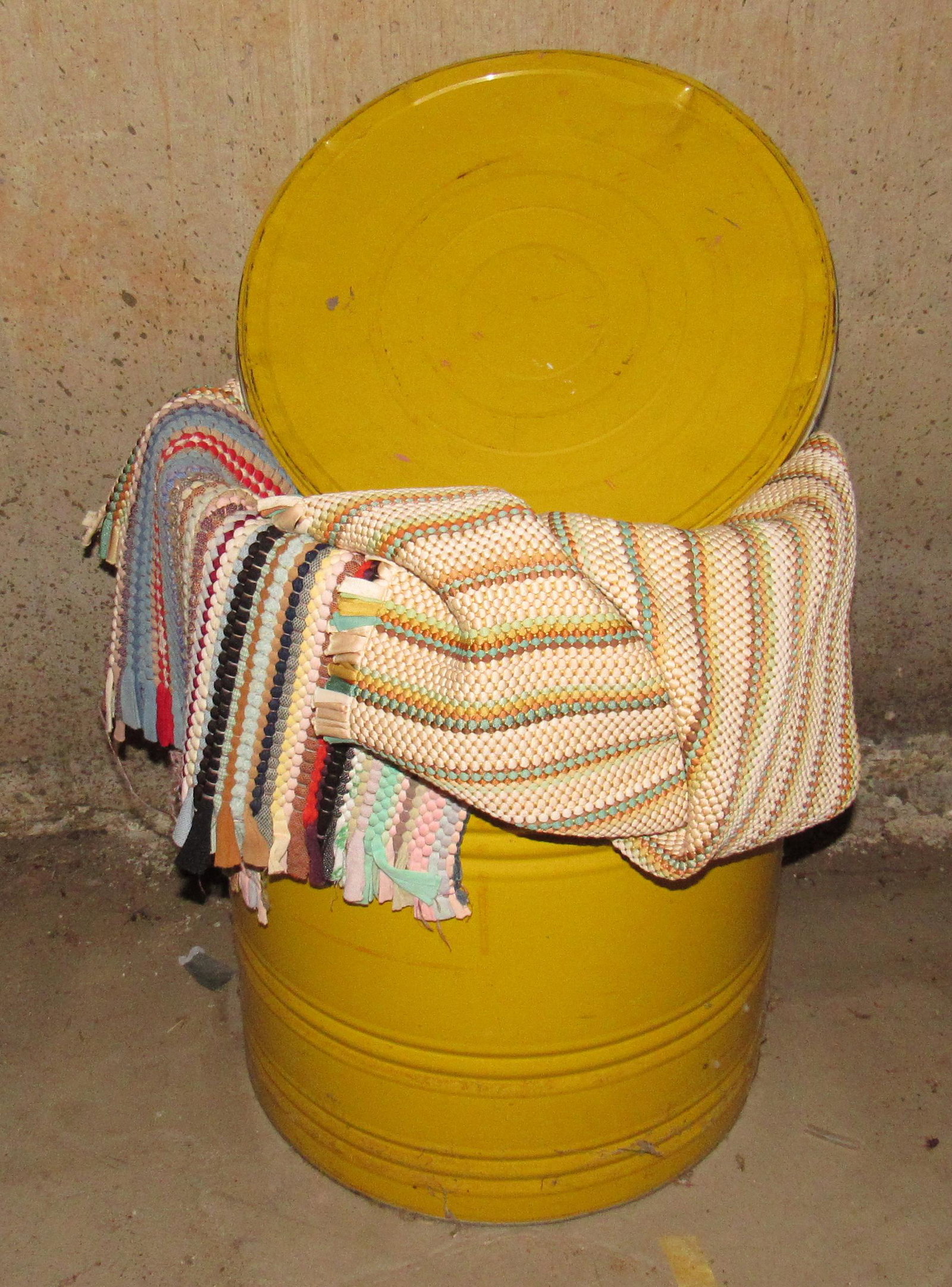 Tin Filled with Rag Rugs: Tin is apprx 16" in diameter and 20 1/2" tall. There are 6 rugs in it.