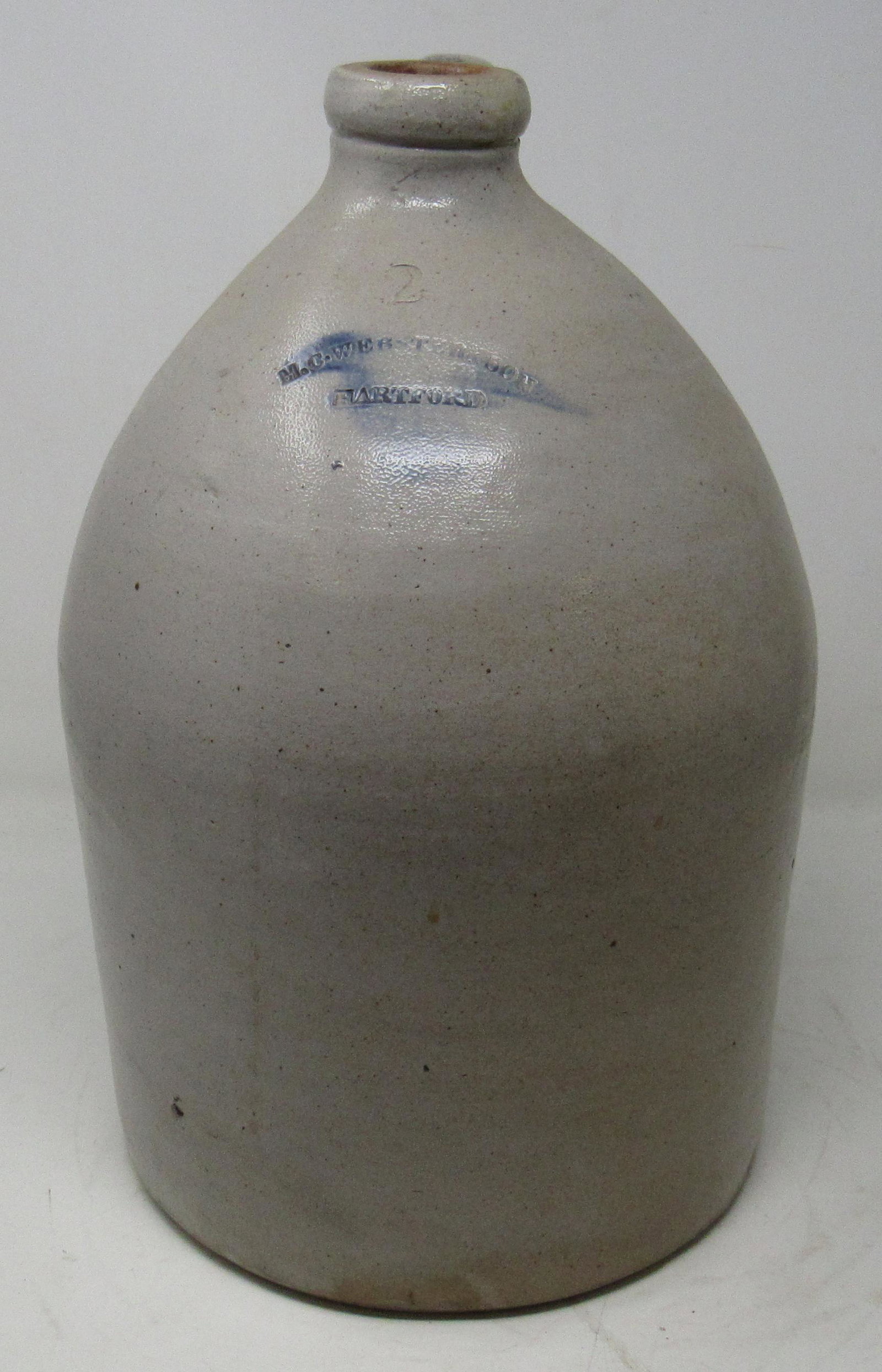 MC Webster Hartford Stoneware Jug: 2 gallon jug, with blue decorated handle. Approx 14" tall.