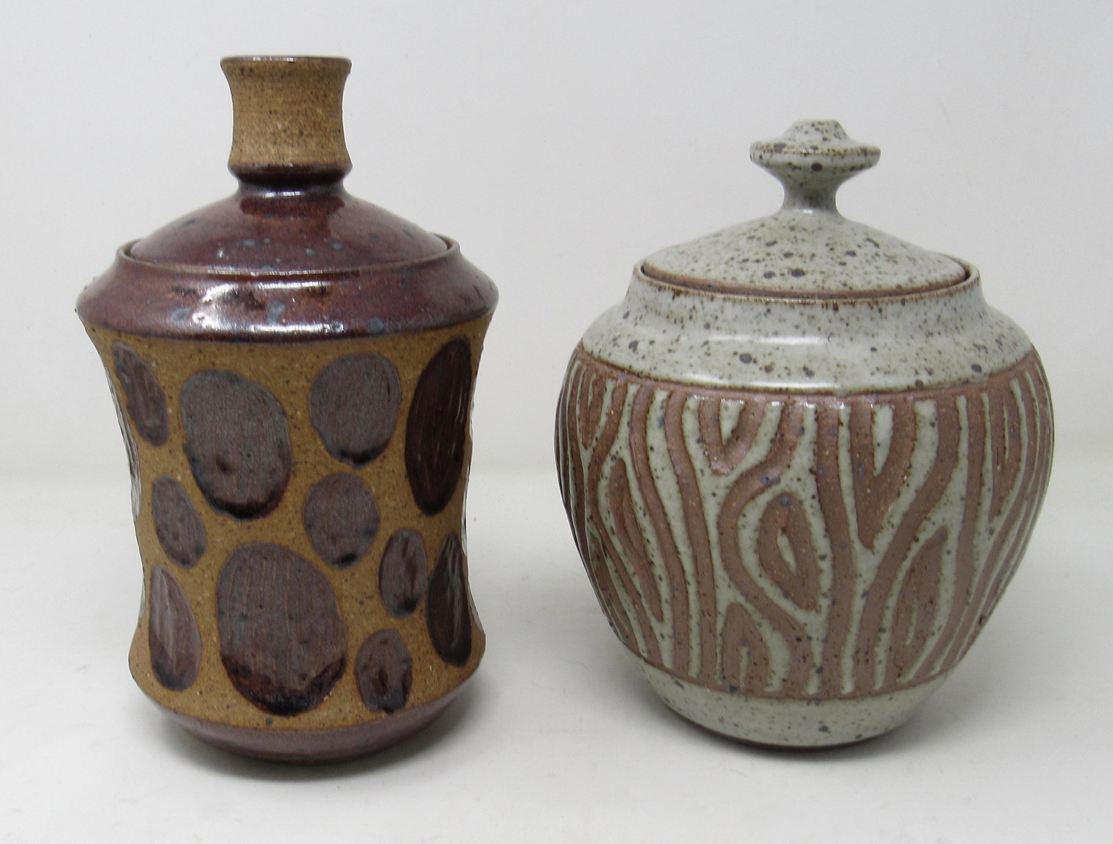 2 Ed Schrock Signed Pottery Jars: Jar on right is approx 6 1/2" in diameter and 9 1/2" tall. Jar on right looks like a candle holder on the top