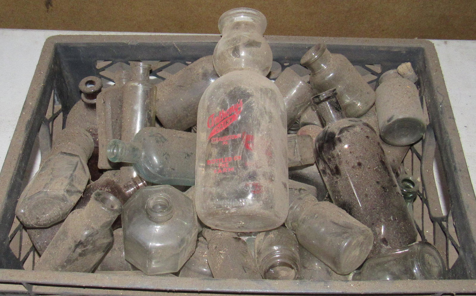 Milk Crate Filled with Misc Bottles: Getting all in crate
