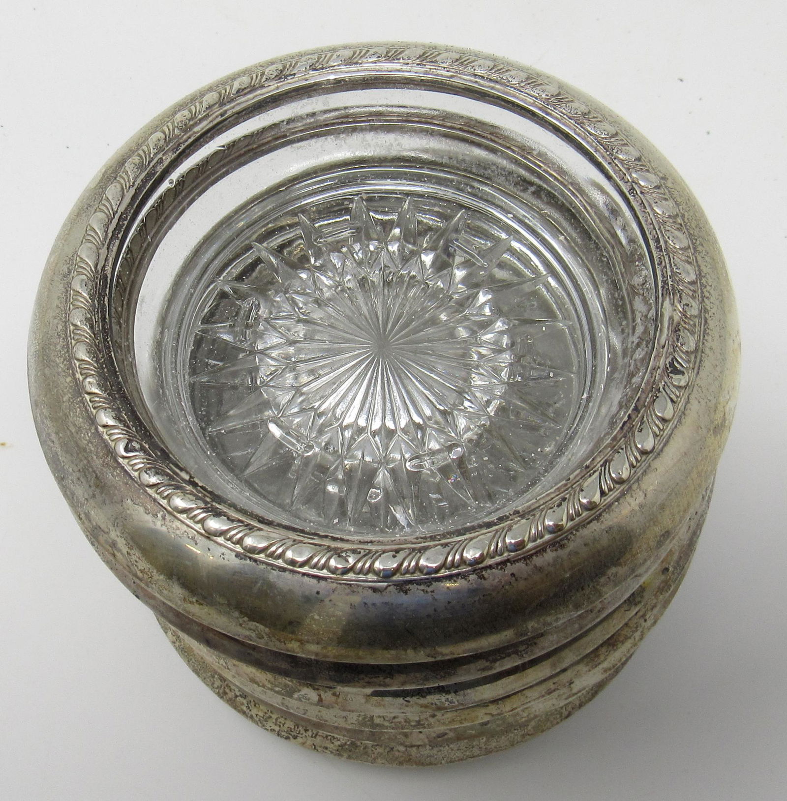 6 Coasters with Sterling Silver ? Bands: Apprx 4" in diameter. Bands are not marked Sterling and not guaranteed to be. Sold as pictured