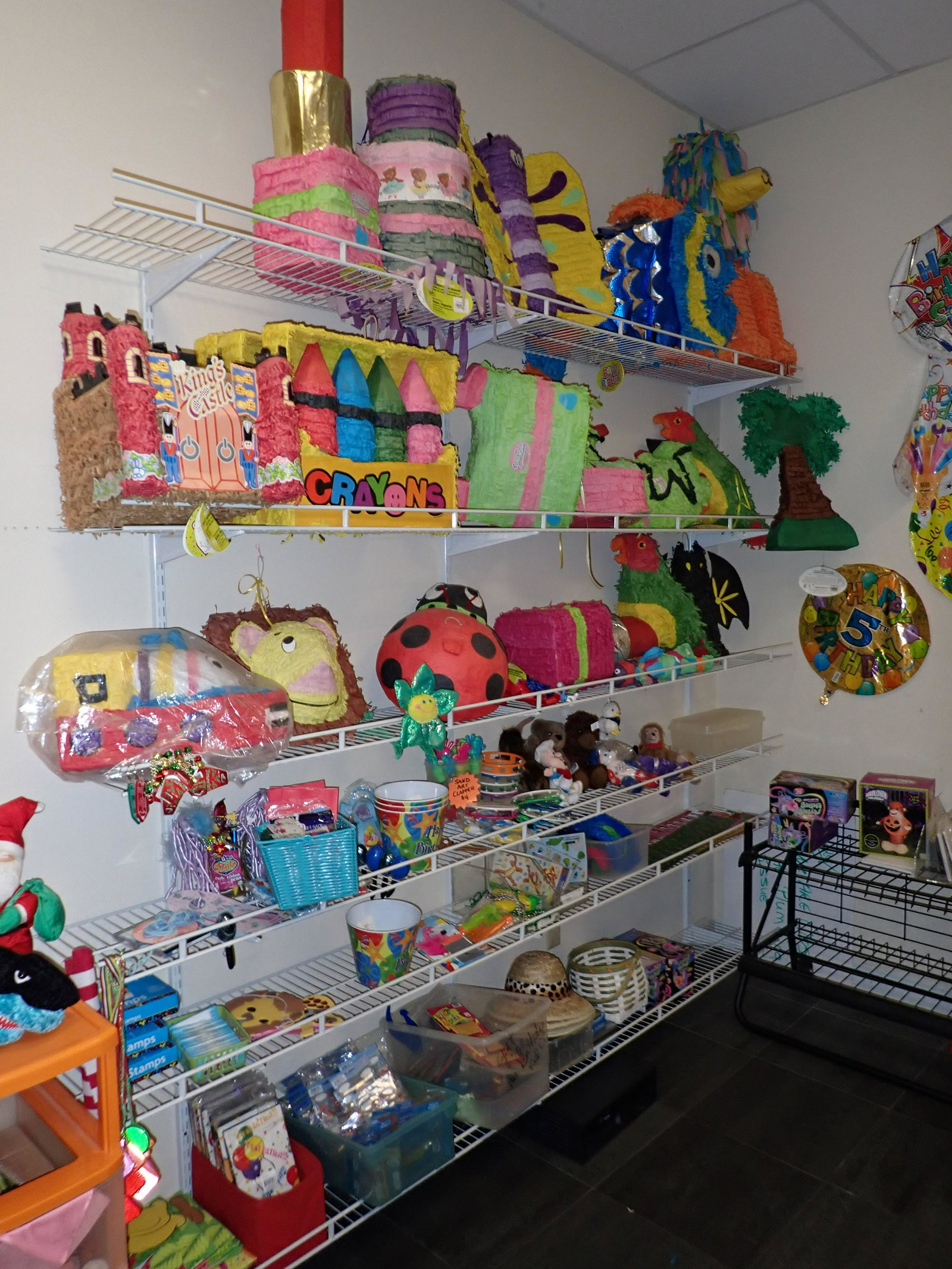Pinatas and Misc: Getting all pictured on the shelves and in the cabinet. Take what you want and leave the rest. DOES NOT INCLUDE SHELVES.