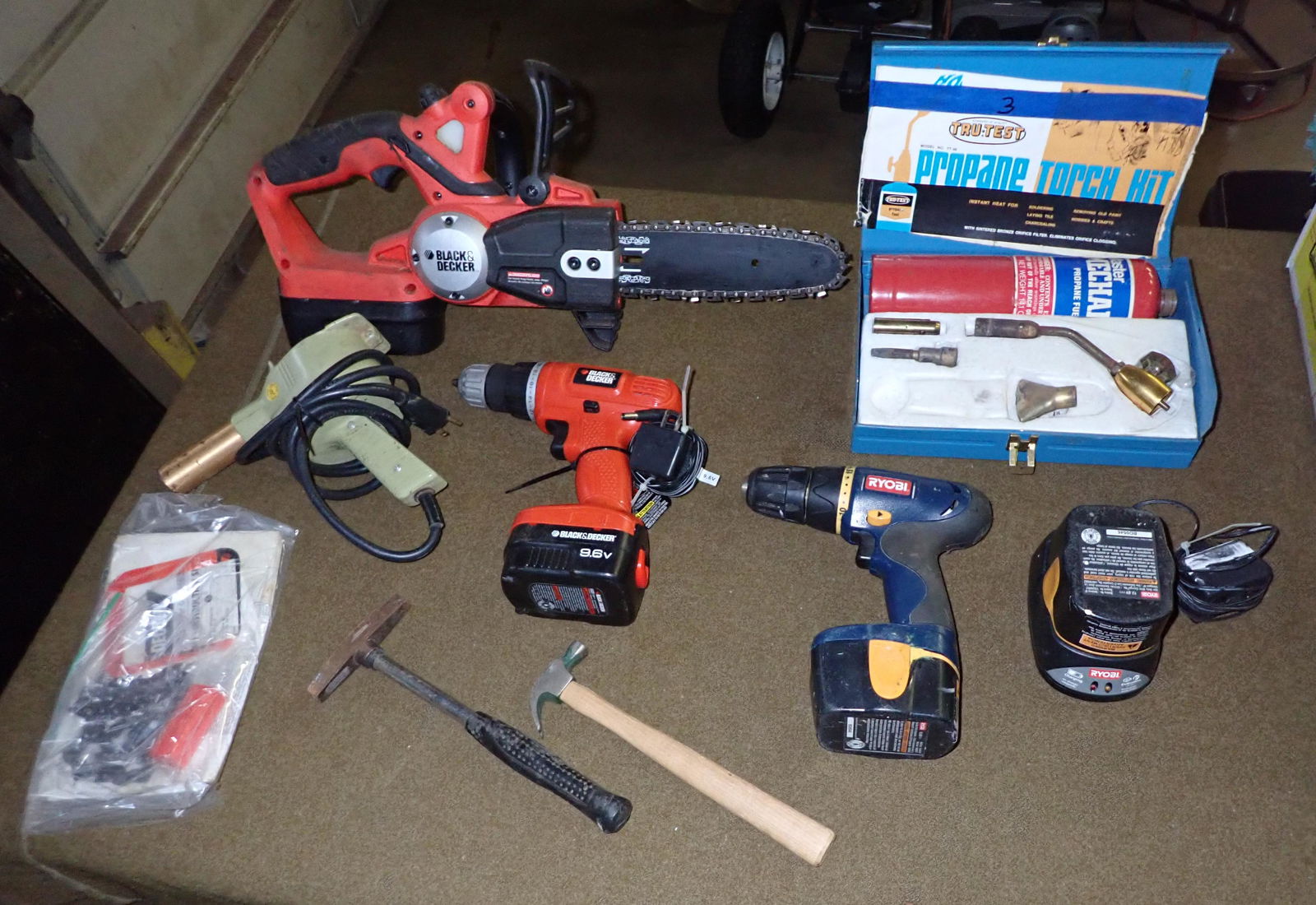 Black & Decker Battery Operated Chainsaw & Contents: Lot includes all pictured on table.