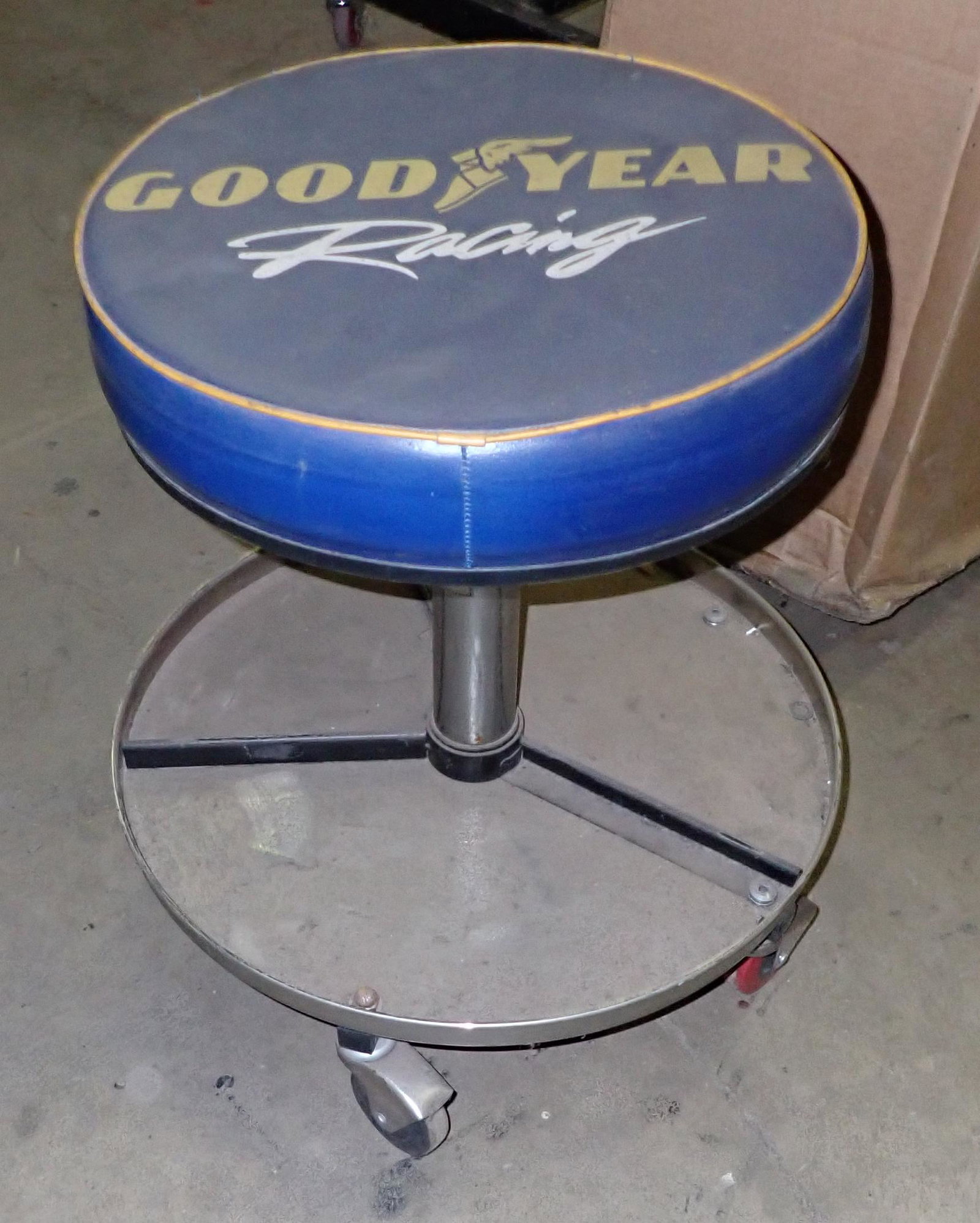 Good Year Racing Shop Stool: On casters and is approx 19" tall ( as pictured ). It is adjustable.