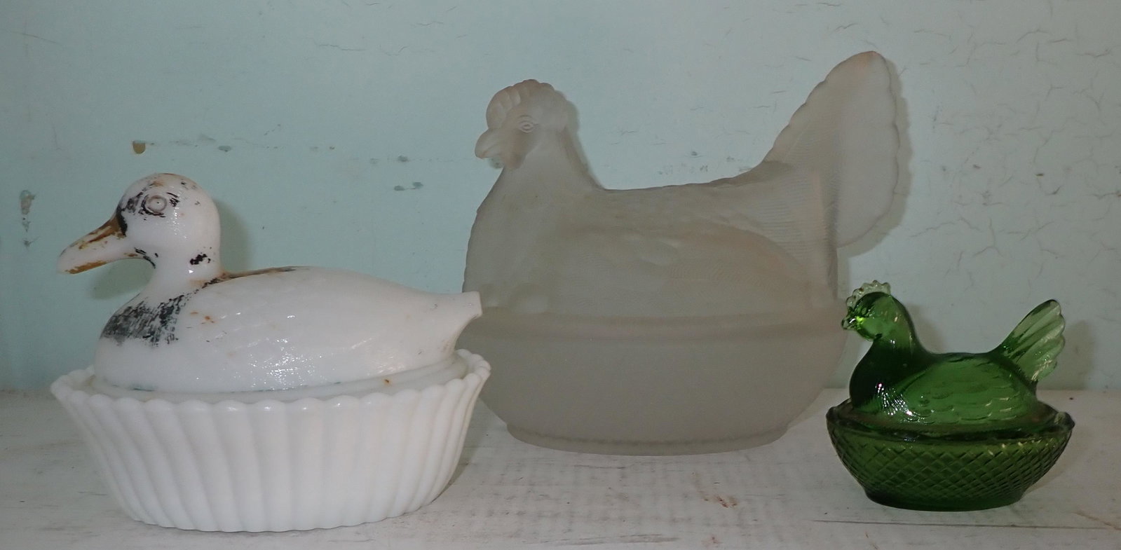 Hens and Duck on Nest: Large Chicken has small chip on nest top edge and slight roughness on top , bottom edge.
