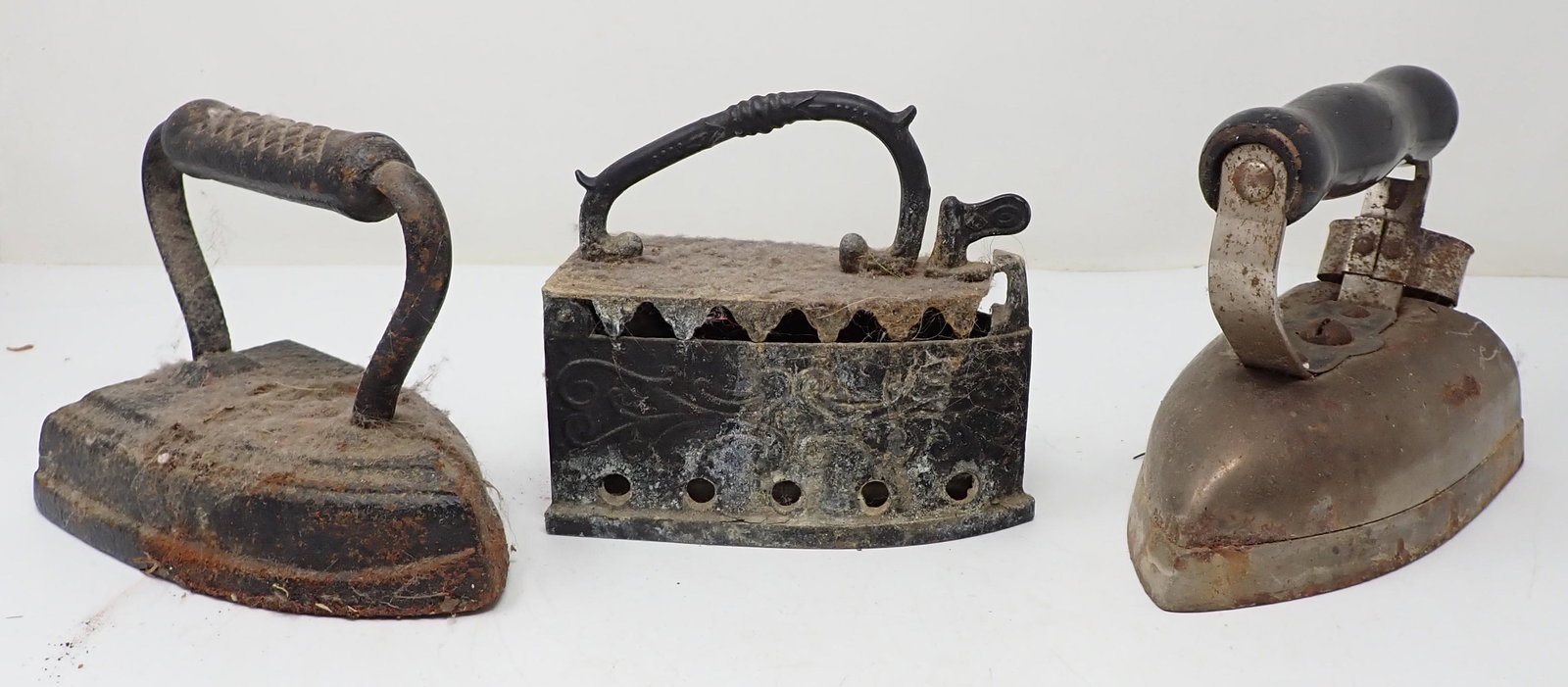 3 Sad Irons: One in middle is cast aluminum
