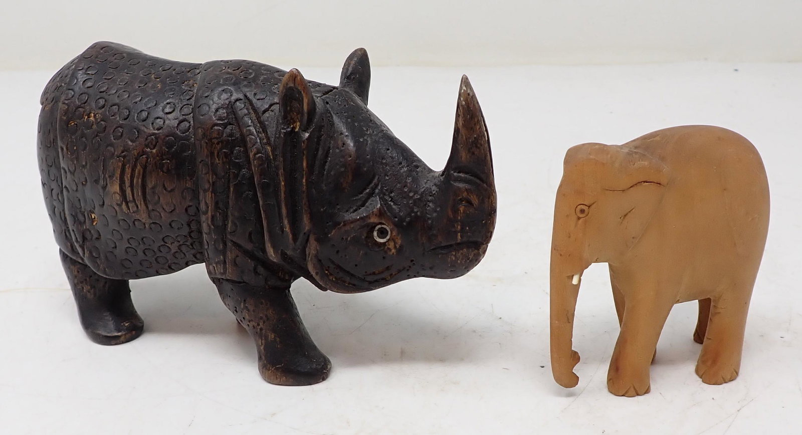 Wood Carved Rhino and Elephant: Rhino is approx 3 3/8" tall.