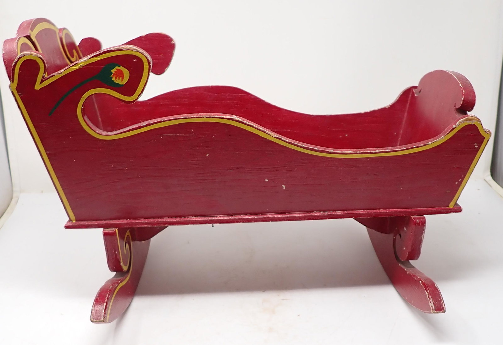 Paint Decorated Doll Cradle: Approx 7 1/2" wide, 16 1/2" long, and 11" tall. Blanket, jacket and hat included