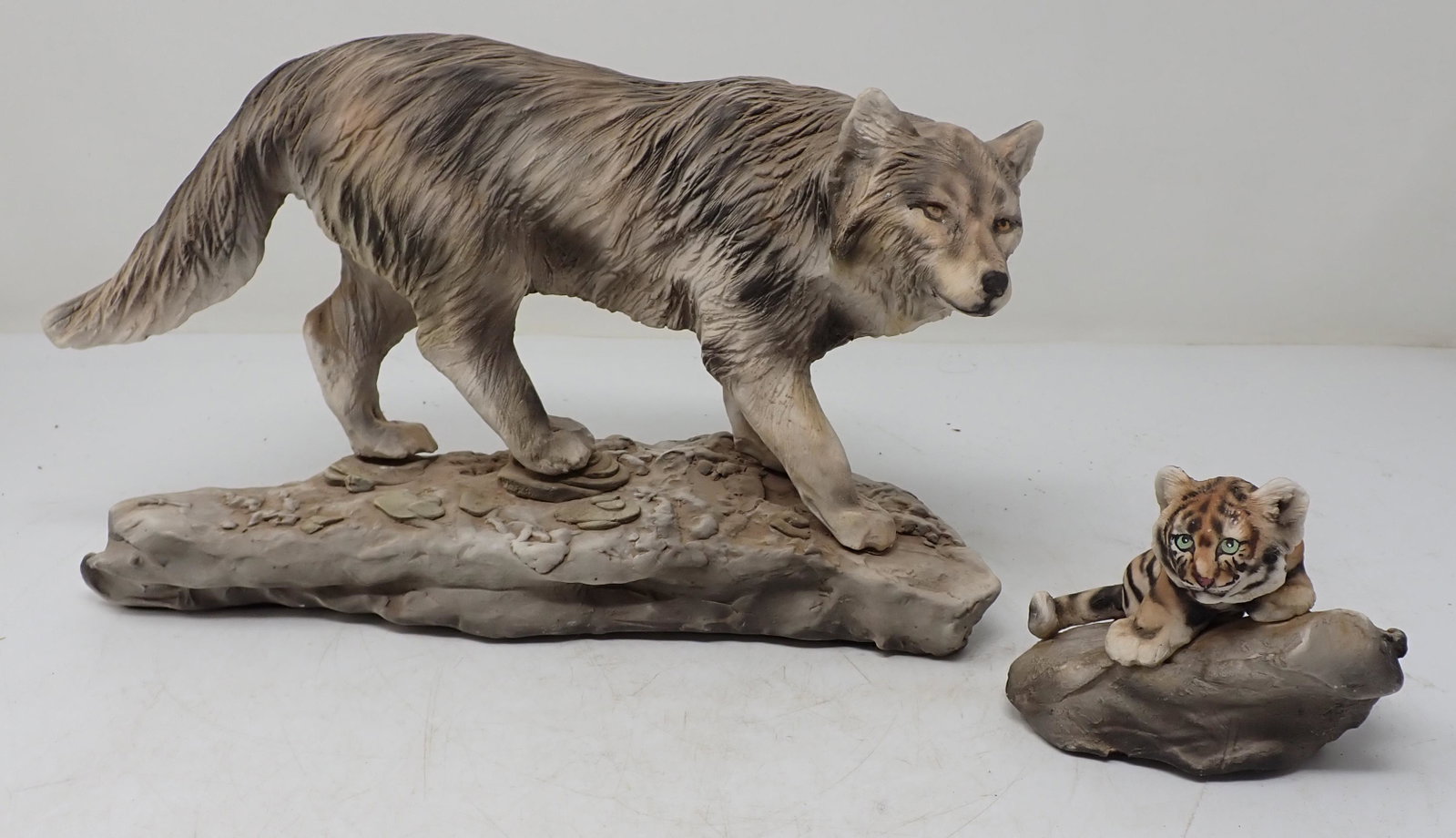 Minette Wolf and Baby Tiger Sculptures: Wolf is approx 10 1/2" long and 7" tall