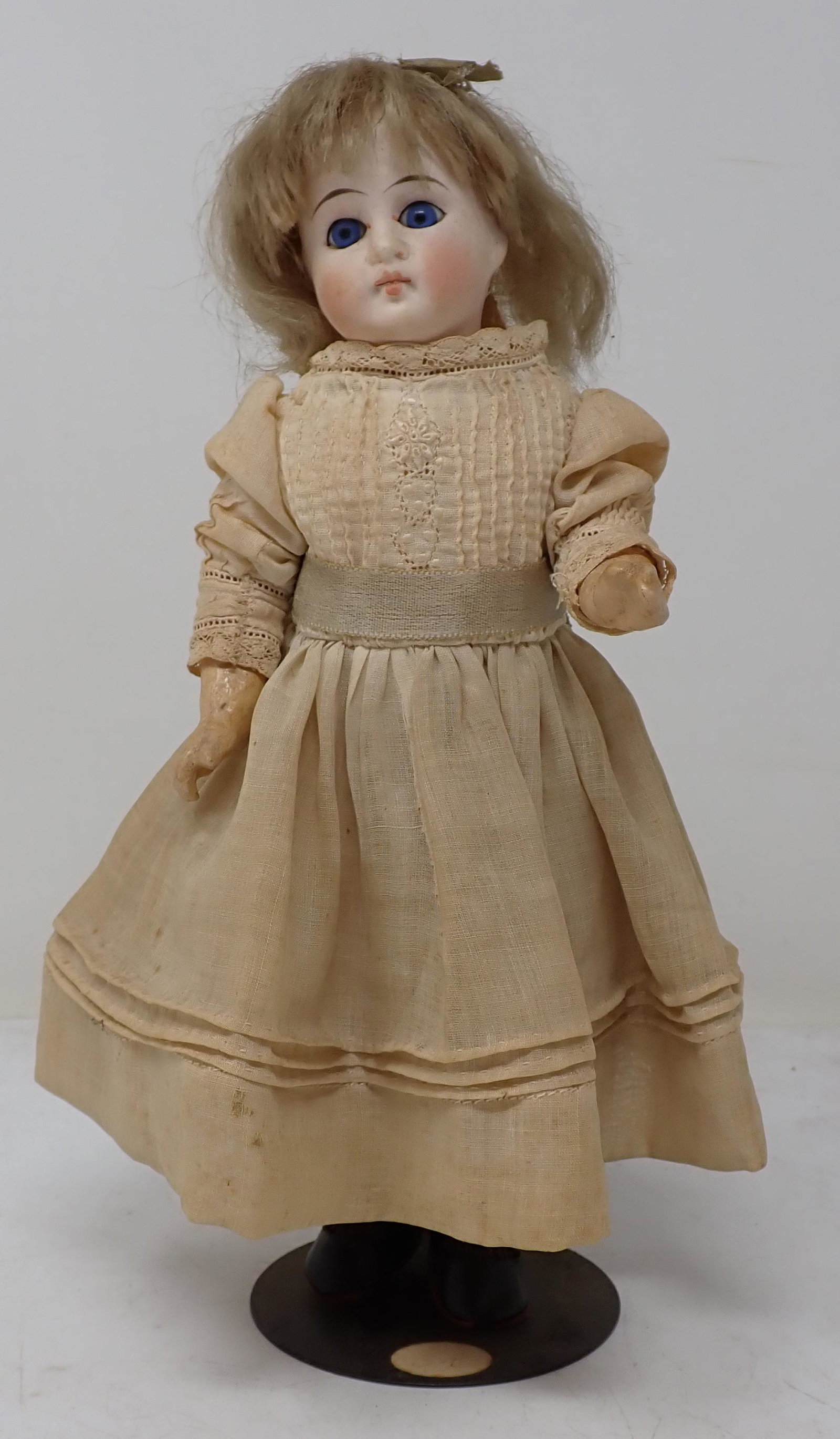Bisque Head #110 Doll w/ Jointed Body: Approx 9 1/2". All dolls in this sale are from an estate of a doll collector and repair shop. If we notice it is repaired, we will mention it. We do not take clothes off and inspect bodies. All are so
