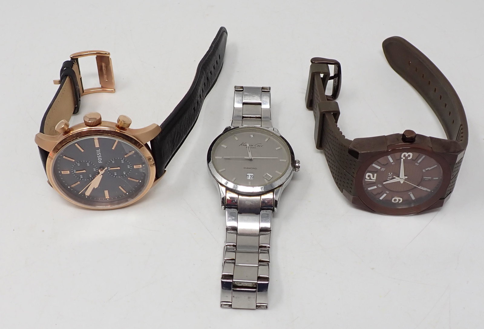 Three Men's Wrist Watches: Including FOSSIL, RELIC, and KENNETH COLE.