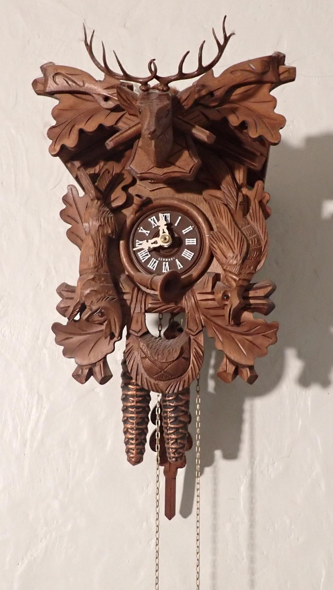 German Cuckoo Clock: Approx 7 1/4" wide and 16 1/2" total length.