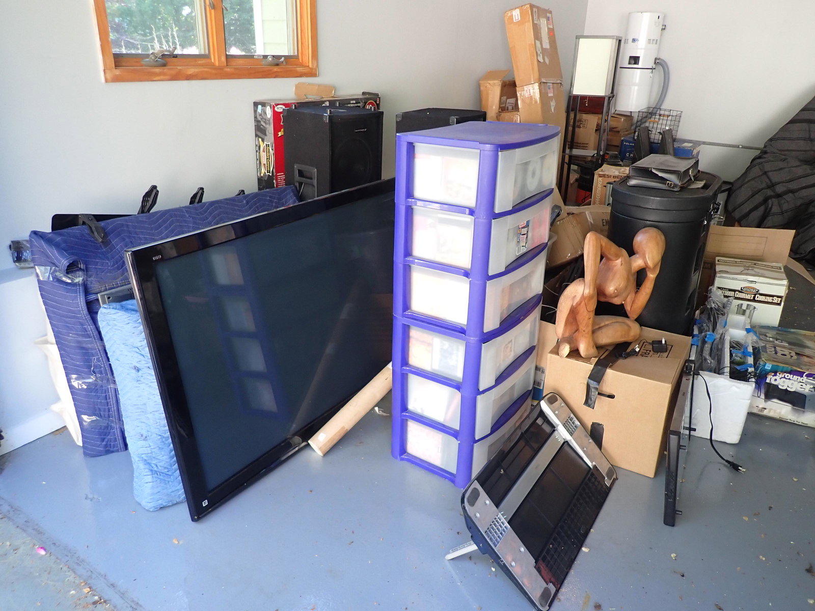 Partial Garage Contents: Lot includes flat screen tv's, cd's plastic cabinet is filled , nude sculpture, MCM Custom Speakers, Bug killing device, fan, Outdoor cooking set, shop vac, glassware, Chafer sets, train set, Display