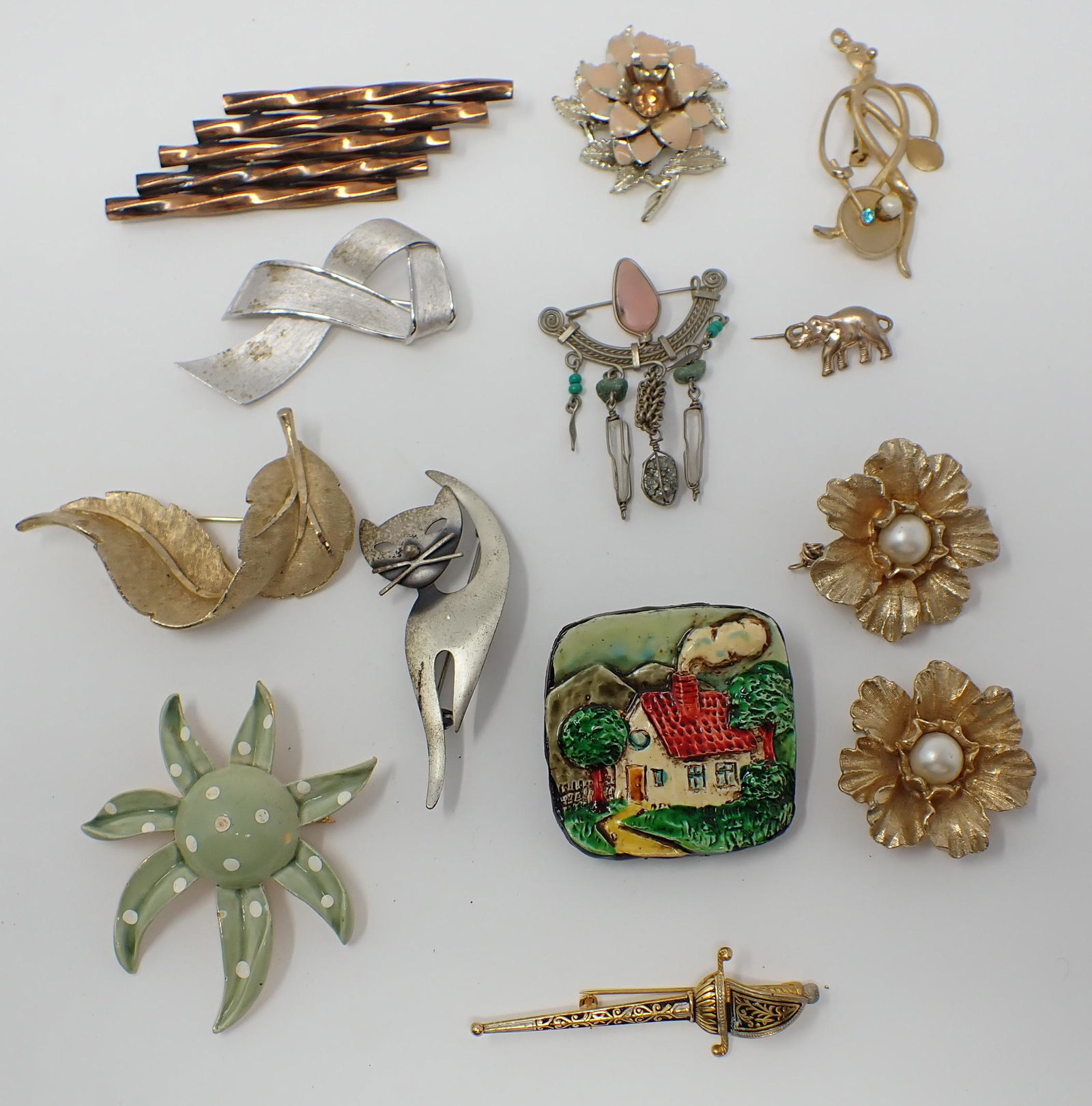 12 Brooches: Various forms including animals, flowers, includes BSK,Trifari, Danecraft sterling cat, etc.