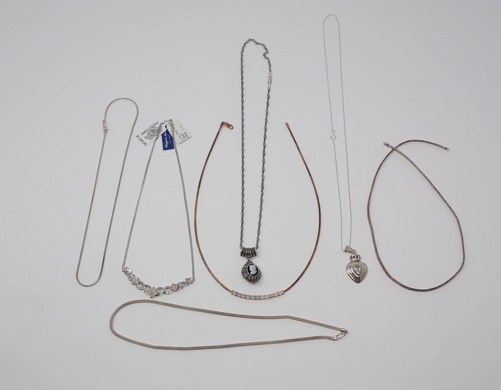 7 Sterling Necklaces: Various styles, with pendants including cameo and marcasite, heart pendant and another with small diamond accents., 2.70 ozt total.