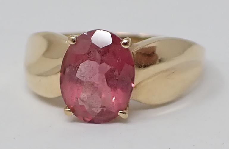 Pink Tourmaline Ring: 14K yellow gold ring marked CID, contains an approx. 9mm x 7mm x 4mm oval brilliant cut pink sapphire, ring size 7-1/4, 2.1 dwt.