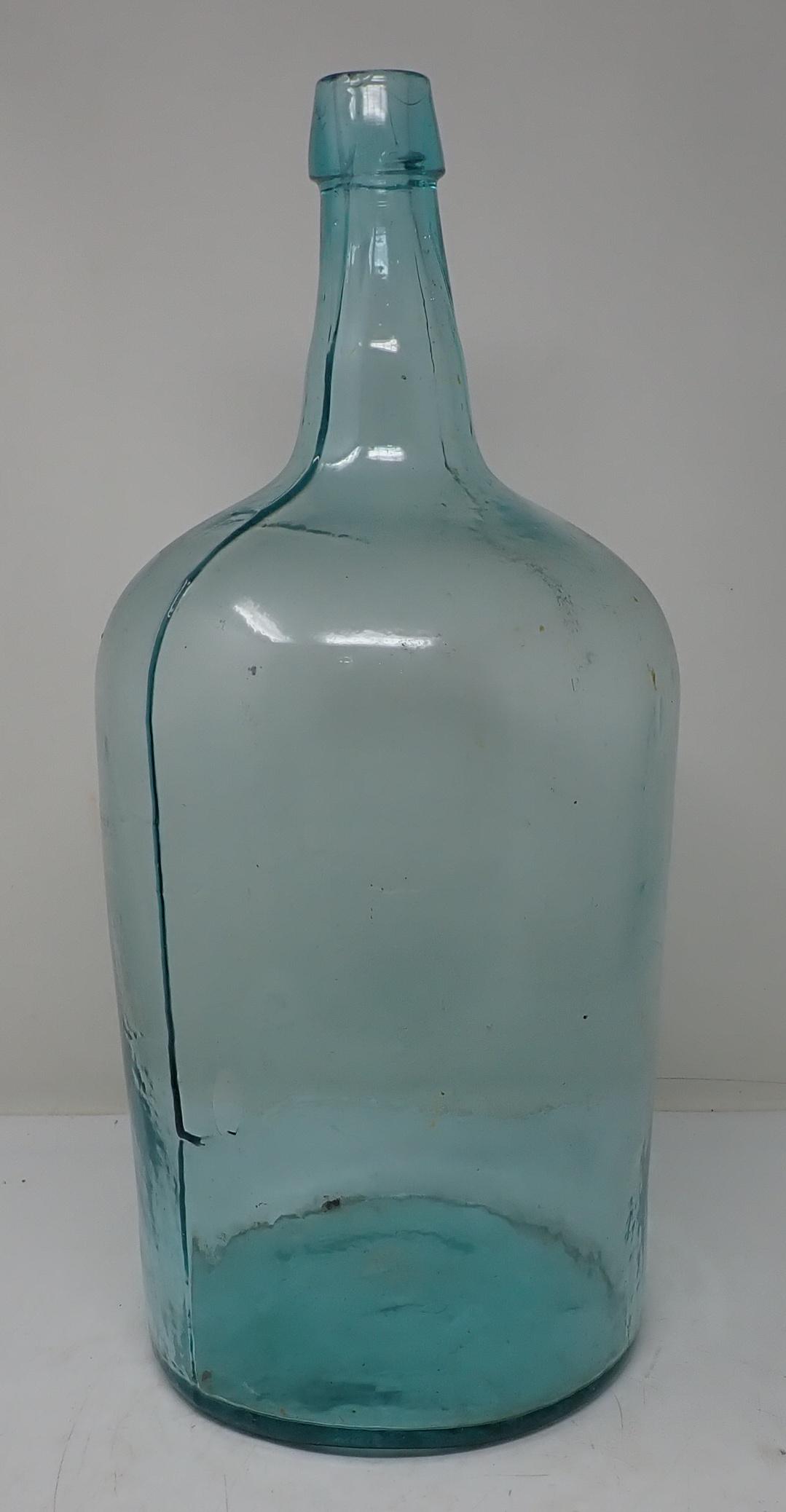Early Glass Bottle: Approx 7 1/4" in diameter at base and 18" tall