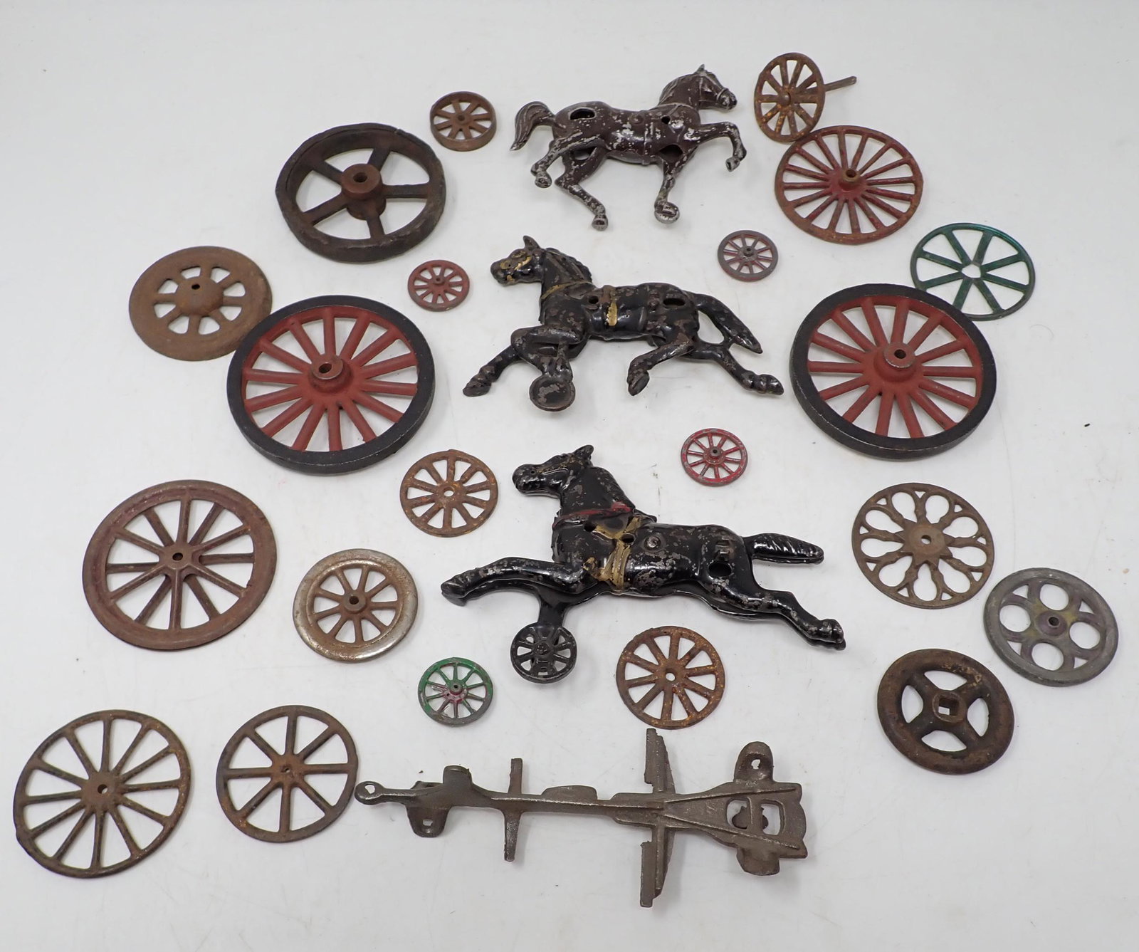 Cast Iron Horse Toy Wheels / Parts: 2 cast iron horses are apprx 6" long. Horse in back is aluminum. Largest wheels are approx 3 1/2" in diameter