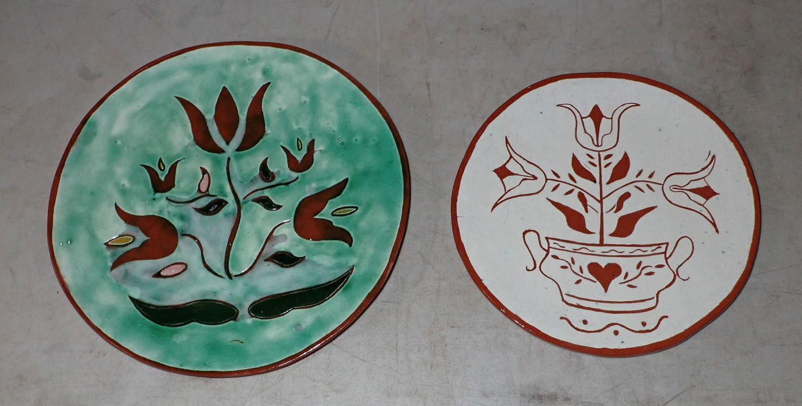 2 Redware Plates: Largest is approx 9 1/4" in diameter. Right one is signed Jane.