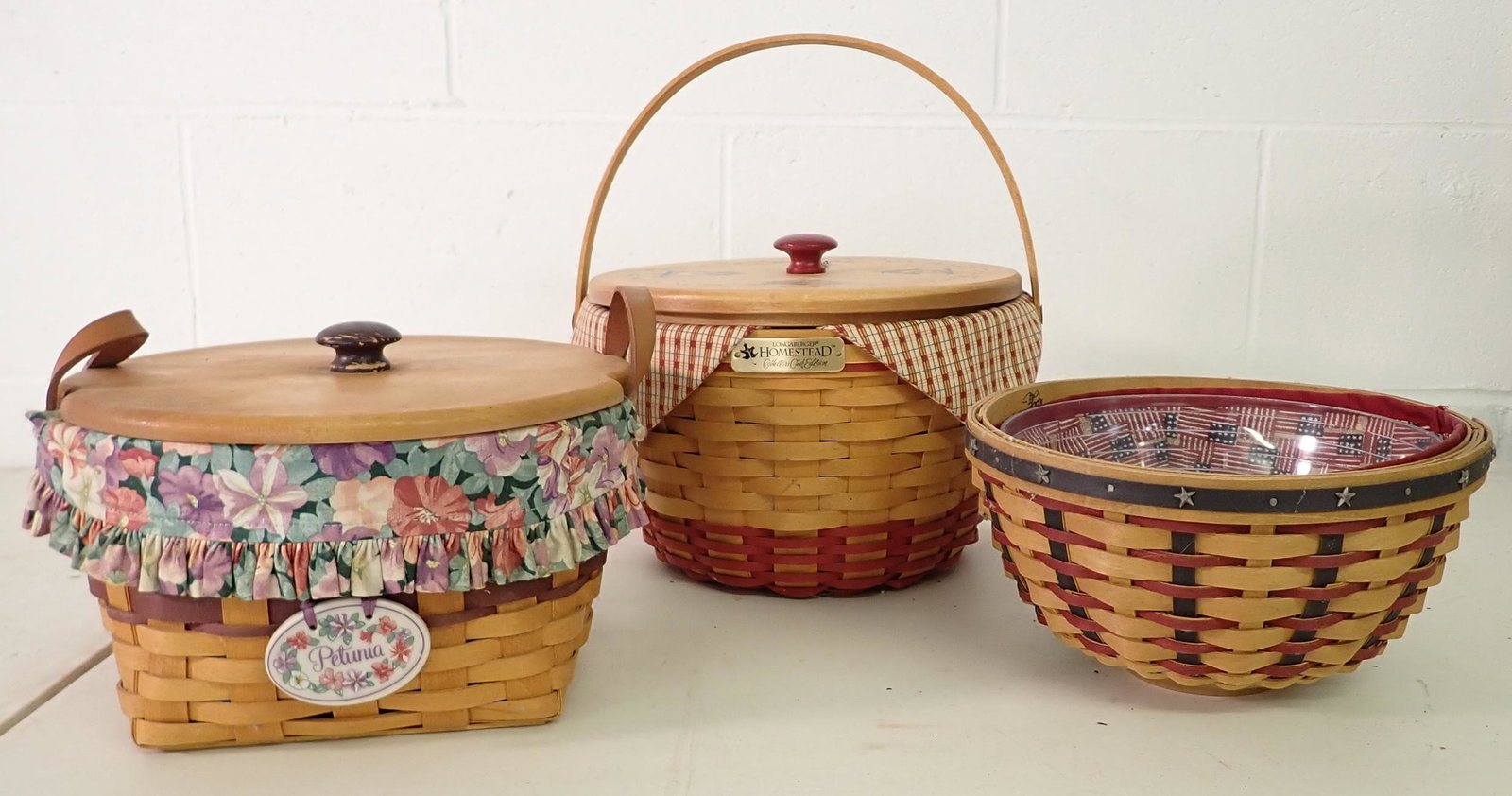 3 Longaberger Baskets: Largest is approx 9 1/2" in diameter and 8" tall. All have protectors and liners