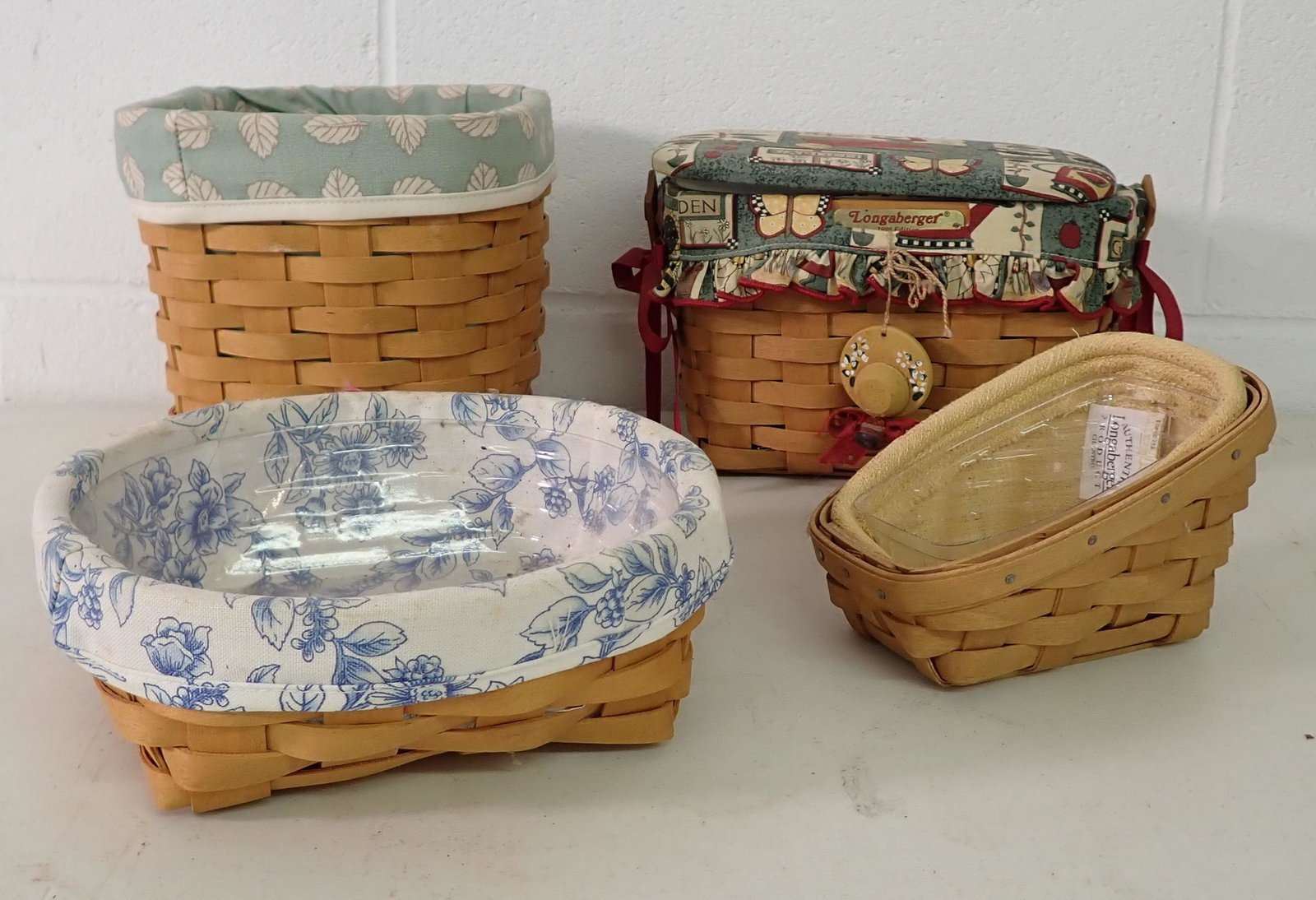 4 Longaberger Baskets: Back left one is apprx 6 1/2" x 6 1/2" x 6 1/4" tall. All have protectors and liners