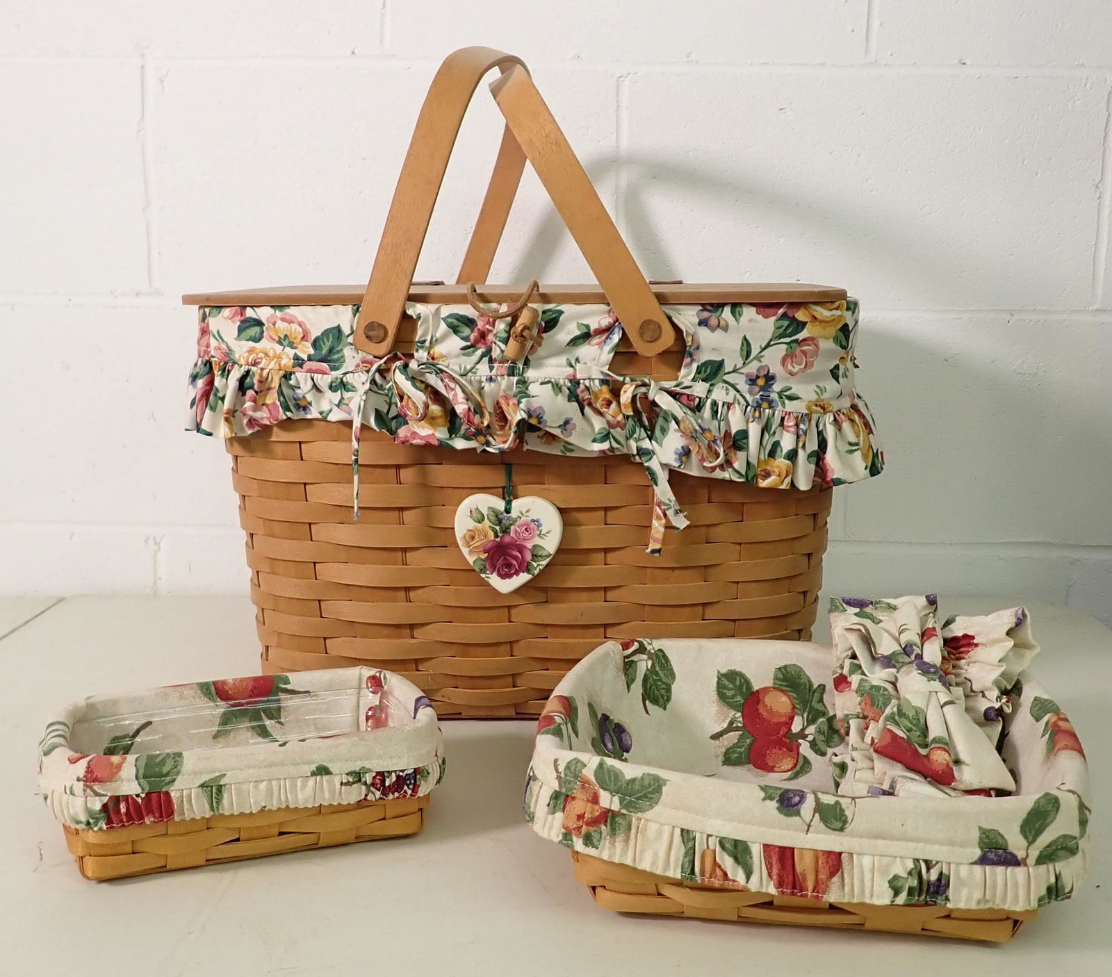 3 Longaberger Baskets: Largest is approx 14" x 16 1/2" x 11" tall. Largest and one on left have protectors and liners. One on right just has liner.