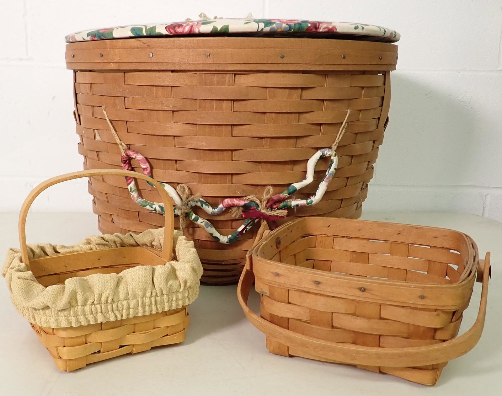 3 Longaberger Baskets: Largest is approx 17" in diameter and 12" tall. Largest has protector