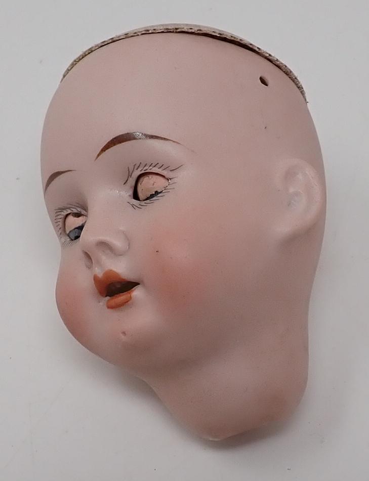 German Bisque Doll Head 21: Approx 3" long. Sleepy eye , open mouth with teeth