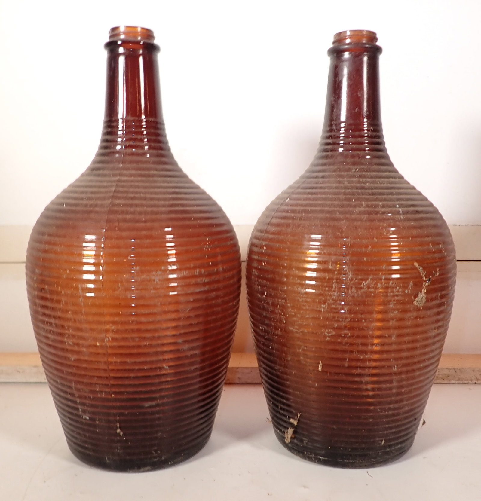 Pair of Amber Bottles: Apprx 6 1/2" in diameter and 13 3/4" tall. NO SHIPPING