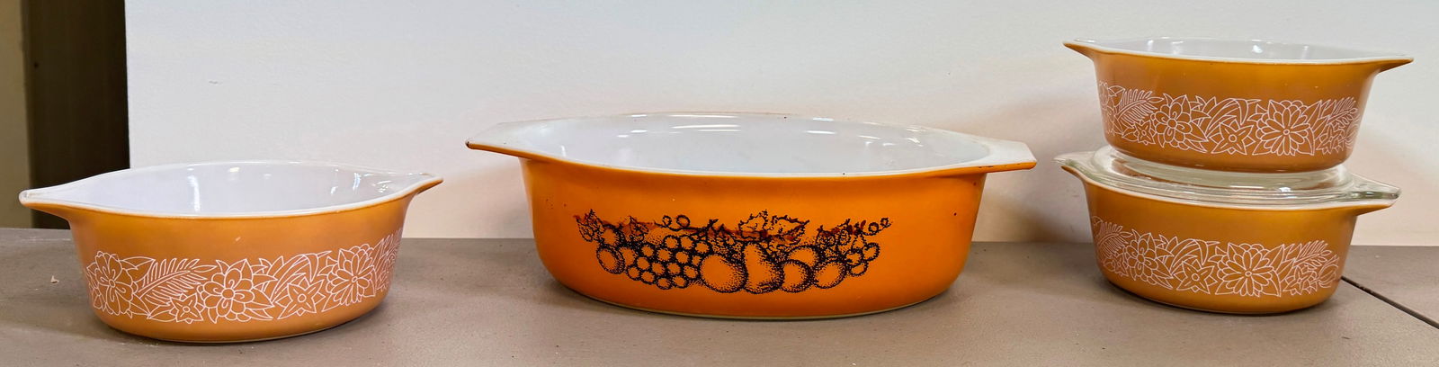 Pyrex Casseroles: Largest is approx 8 1/2" x 12 5/8" x 3 1/4" tall. Only one small one has a lid.