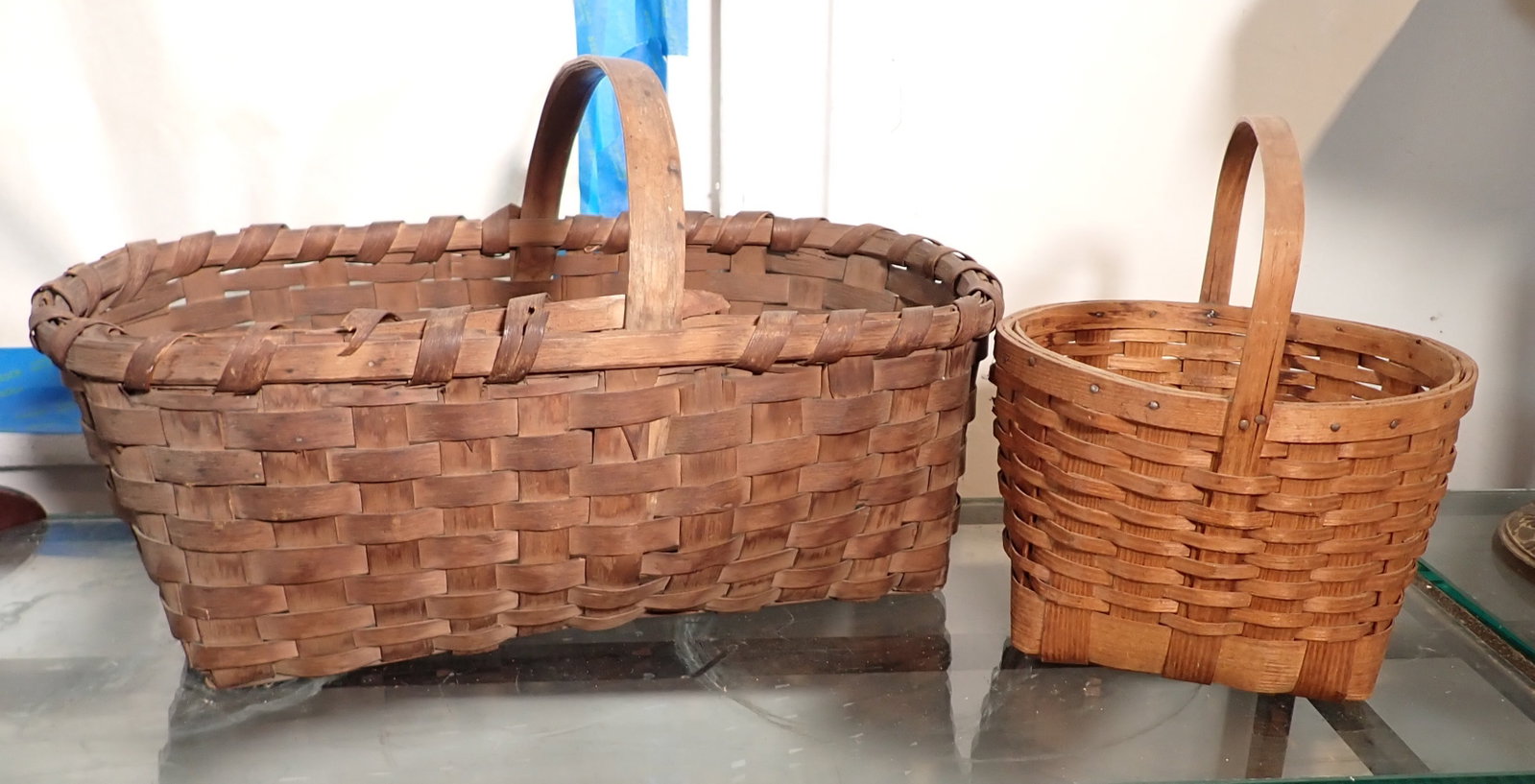 2 Baskets: Largest is approx 12" x 19 1/2" x 10 1/2" to top of handle. NO SHIPPING