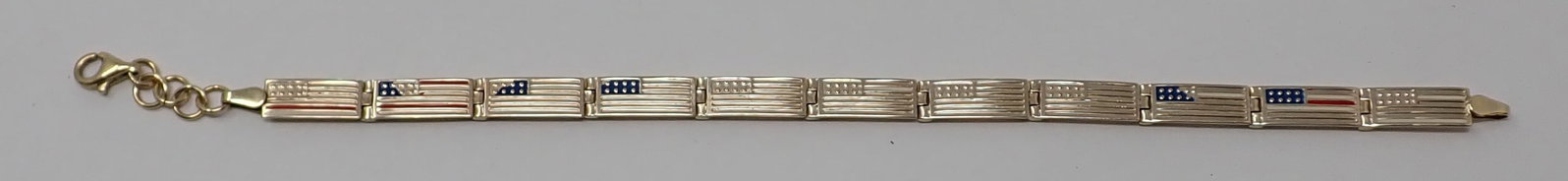 Patriotic Gold Bracelet: Turkey, 10K yellow gold, constructed from 11 enameled American flag links and chain extension, some enamel loss, 7.75" total length, 4.74 dwt