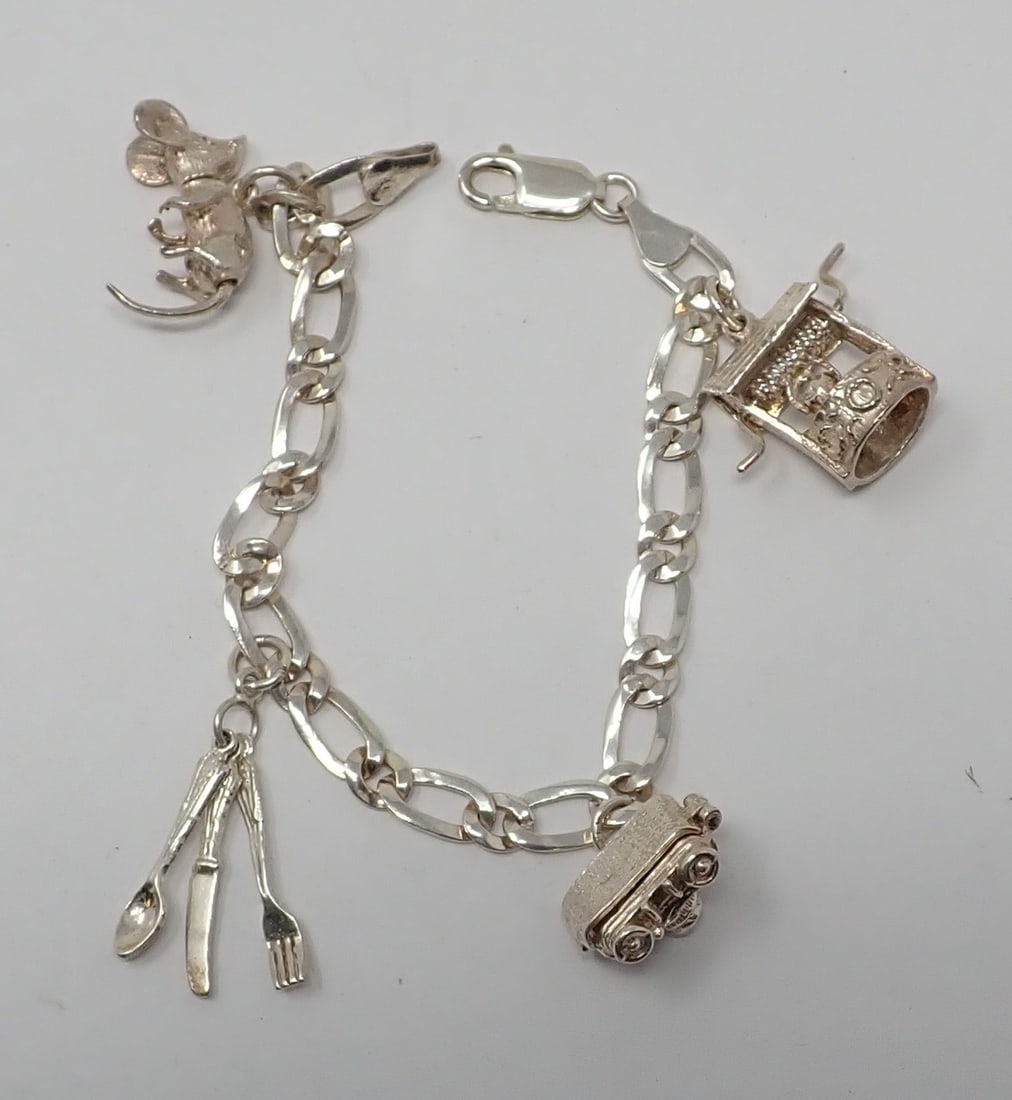 Sterling Charm Bracelet: Sterling 7" mariners link chain supporting 4 sterlin charms including a wishing well, camera, utencisl and a mouse with motion, 0.670 ozt