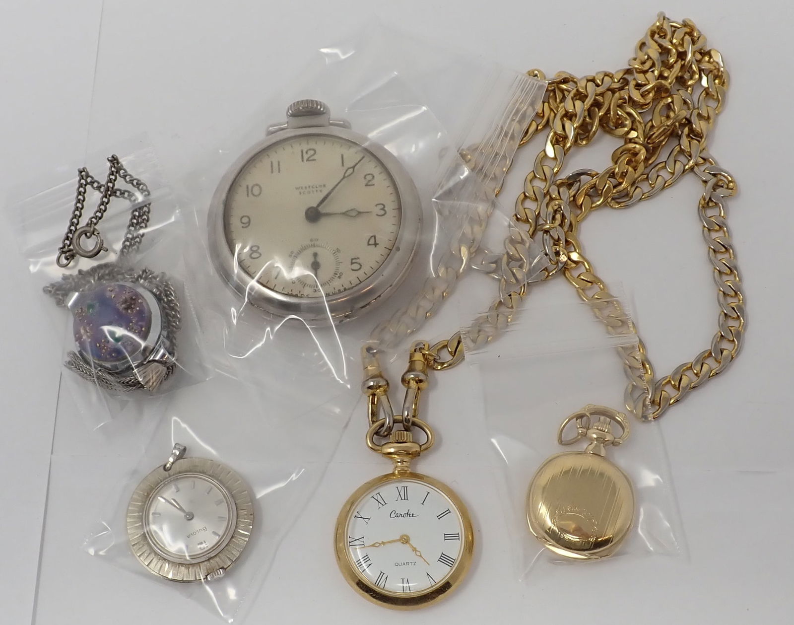 Pocket Watches and Pendant Watches: Includes a silver-tone Wilcox Scotty; gold-tone Carolee on a chain; small gold-tone Belair; silver-tone Bulova; and a silver-tone Harvester with art glass decoration and supported by a chain