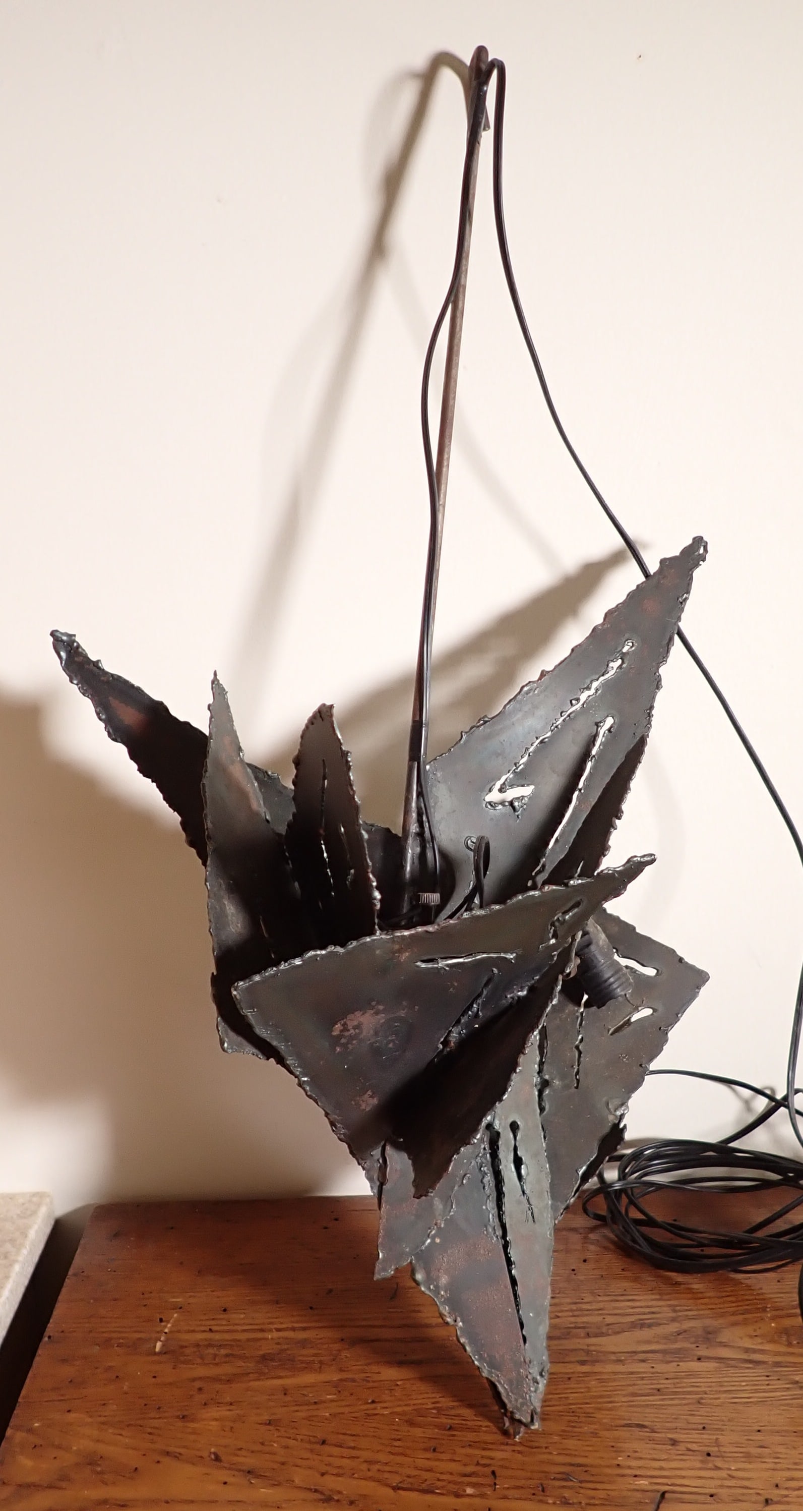 Hanging Steel Art Sculpture: Approx 18" x 31". Someone wrapped lighting around it. No shipping