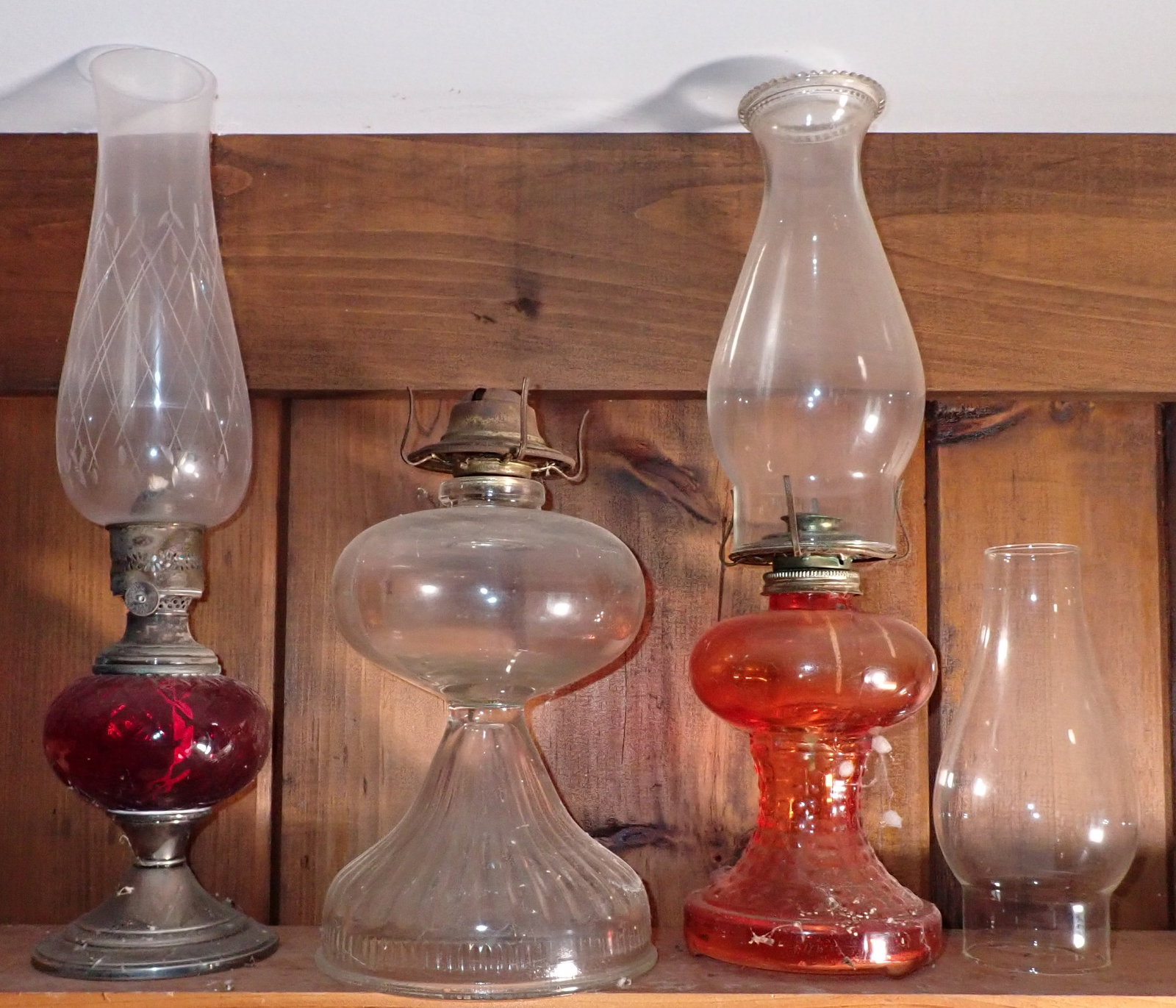 3 Oil Lamps: Left one is apprx 16 5/8" tall. Chimney on left does not go to the one without a chimney. No shipping