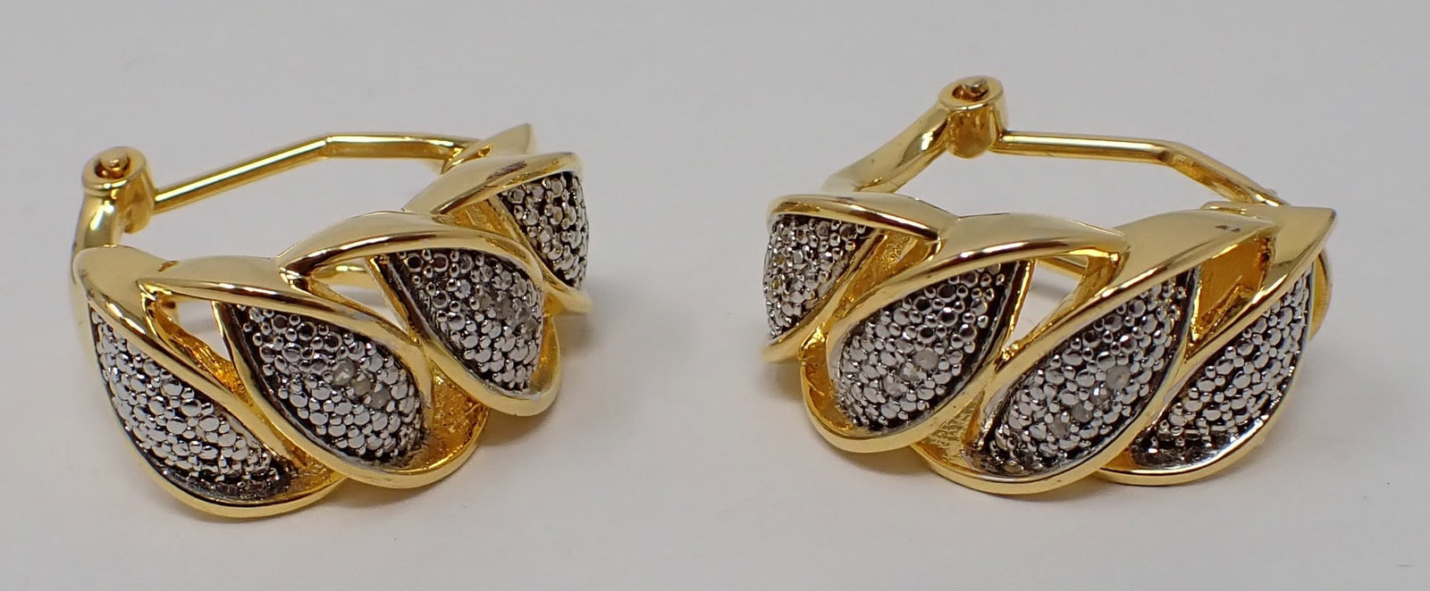 14k Yellow Gold Over Brass Earrings: .05 CTW Diamond Designer Earrings. Clarity - 12 , Color - Near colorless, round cut, Height- 75mm, width - 75mm, depth 55mm.