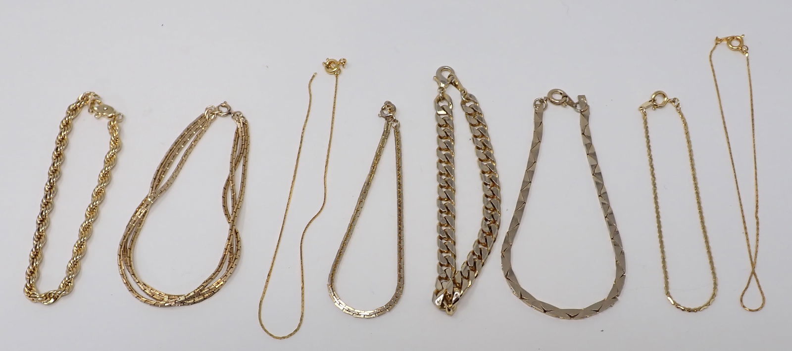 Costume Bracelets: 8 Gold-tone chain bracelets.