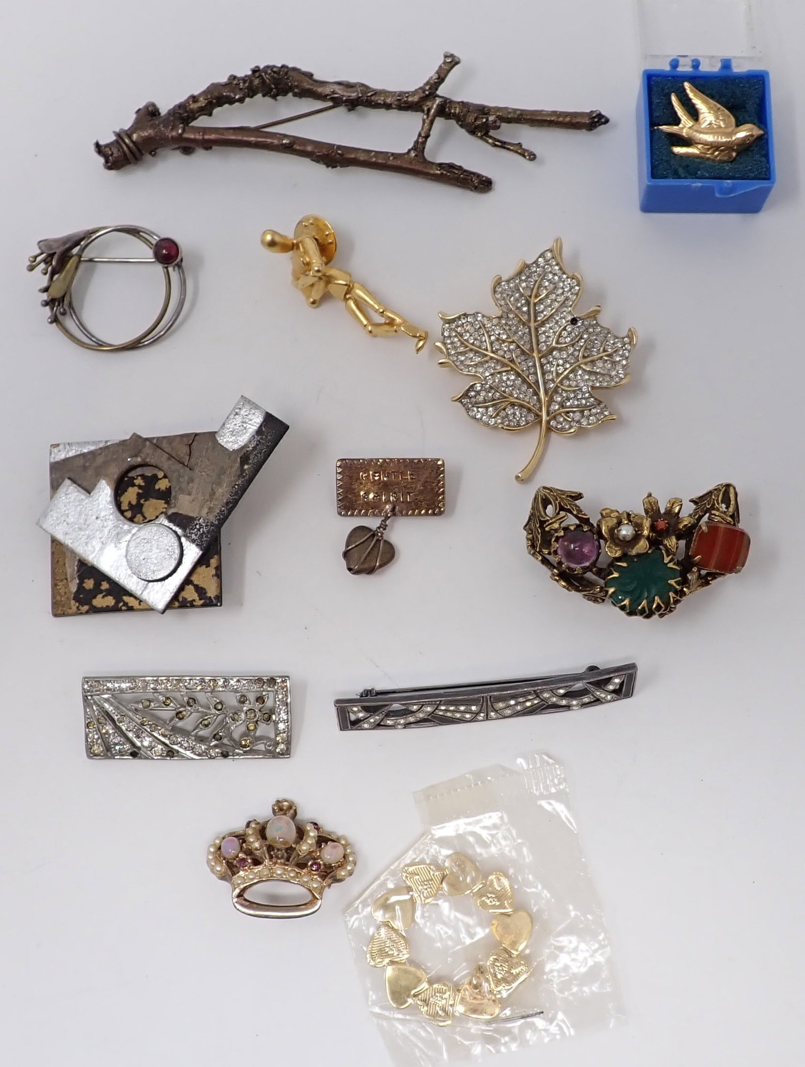 Costume Brooches: Includes a rhinestone Trifari leaf pin, branch form pin, cluster pin and more.